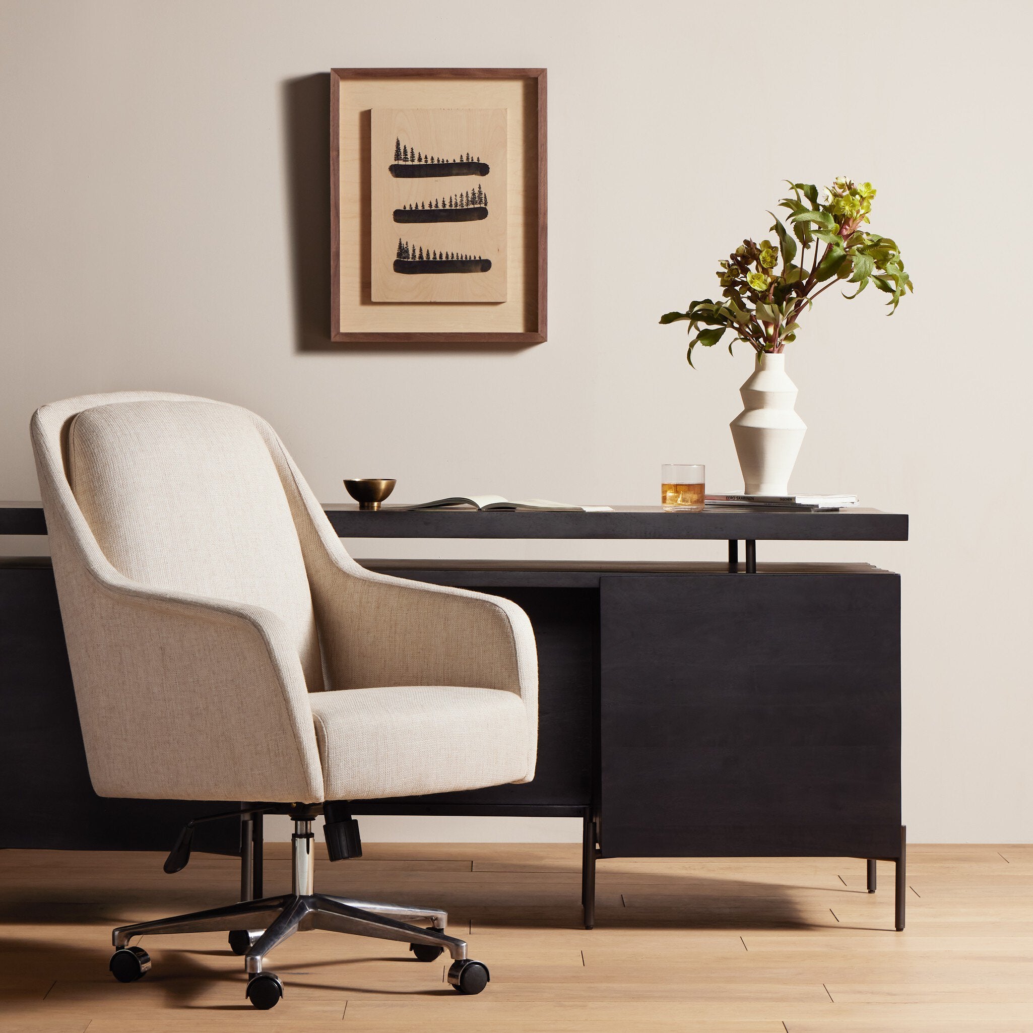 Modern office desk with chair, framed artwork, and decorative items. | Wildwood Home Co.