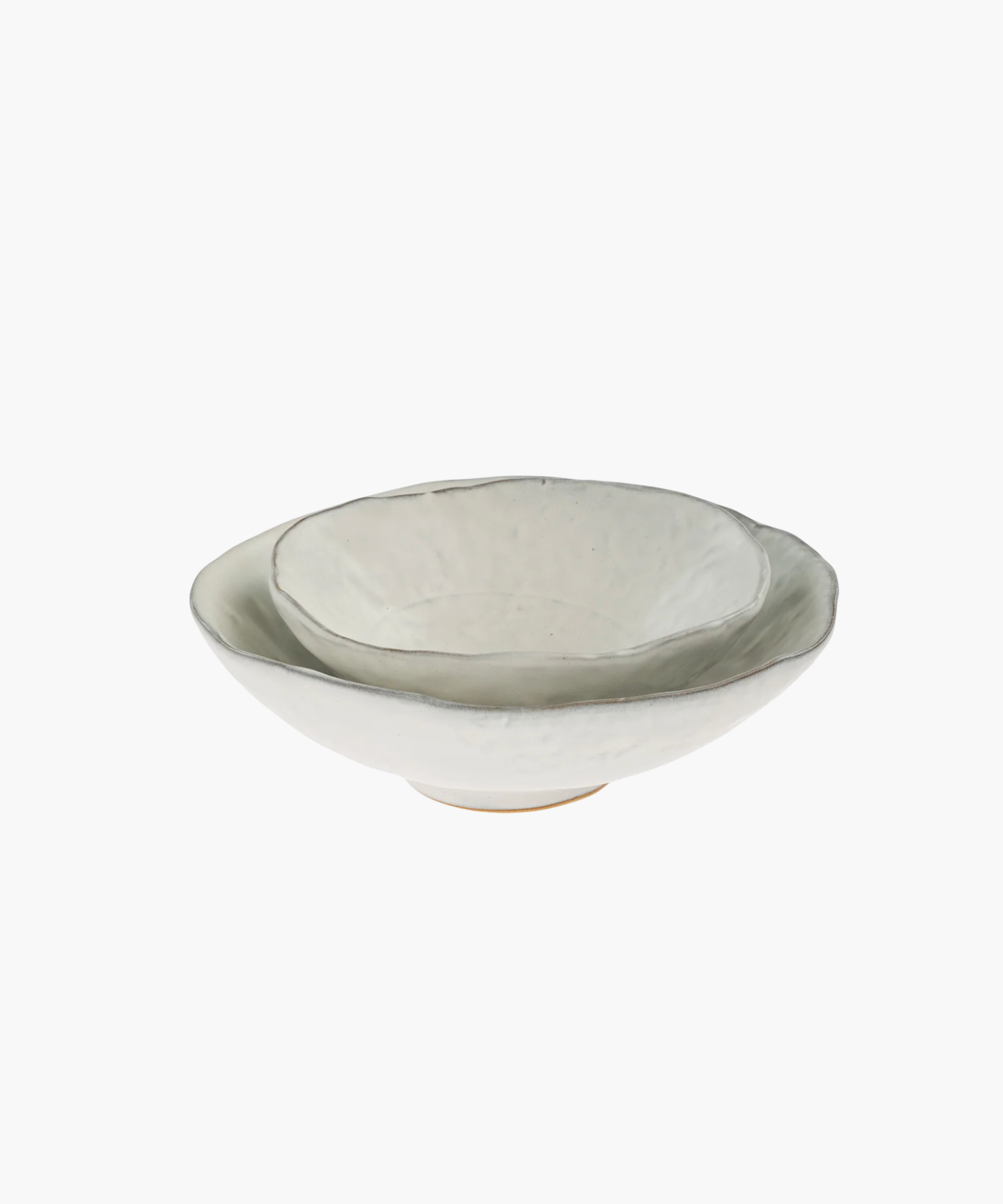 A neutral tone ceramic bowls with an organic, uneven rim and textured surface. The bowl's simplicity and elegance convey an artisanal and minimalist design. | Wildwood Home Co.
