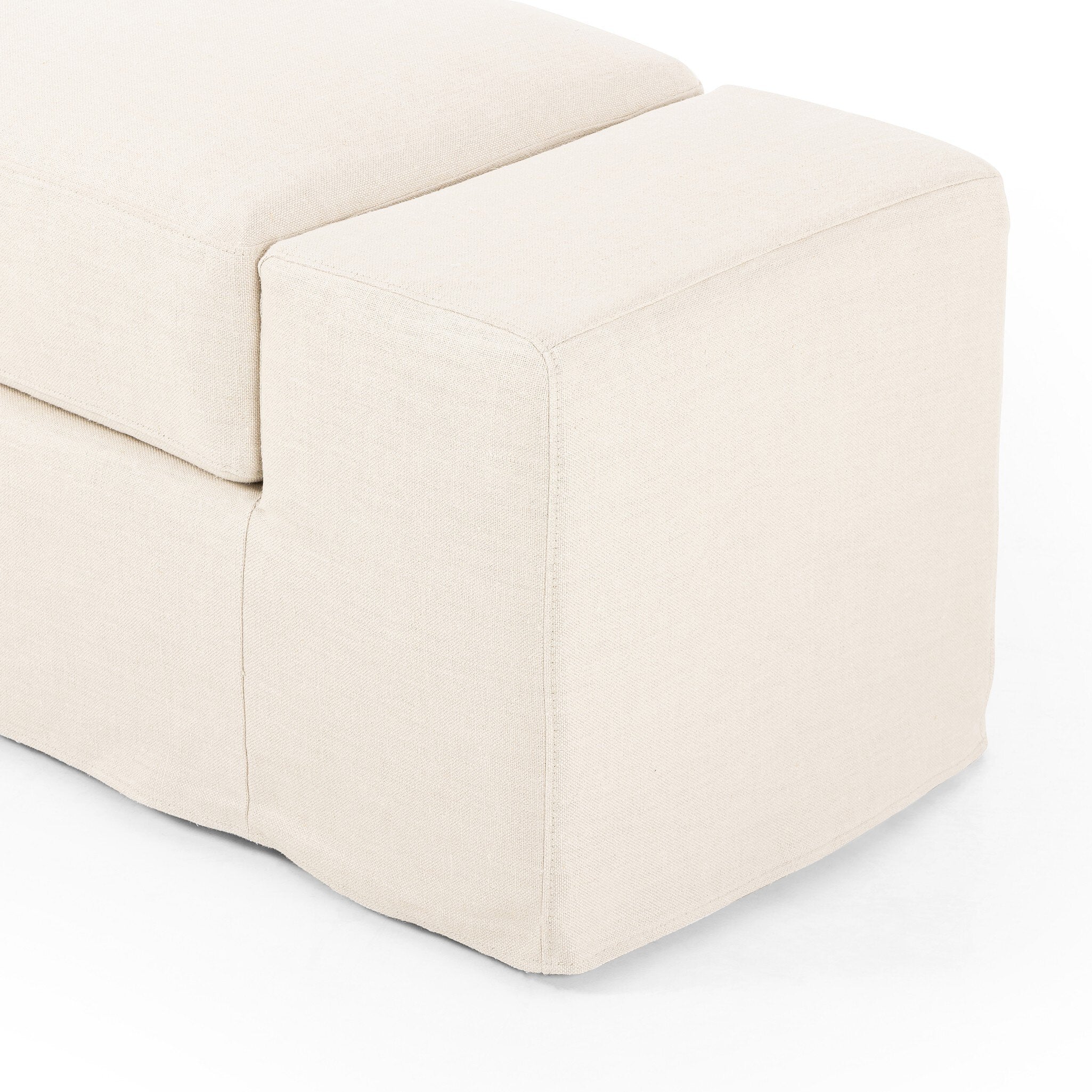 Side View of Ivory wide arm slipcover accent bench on a white background.