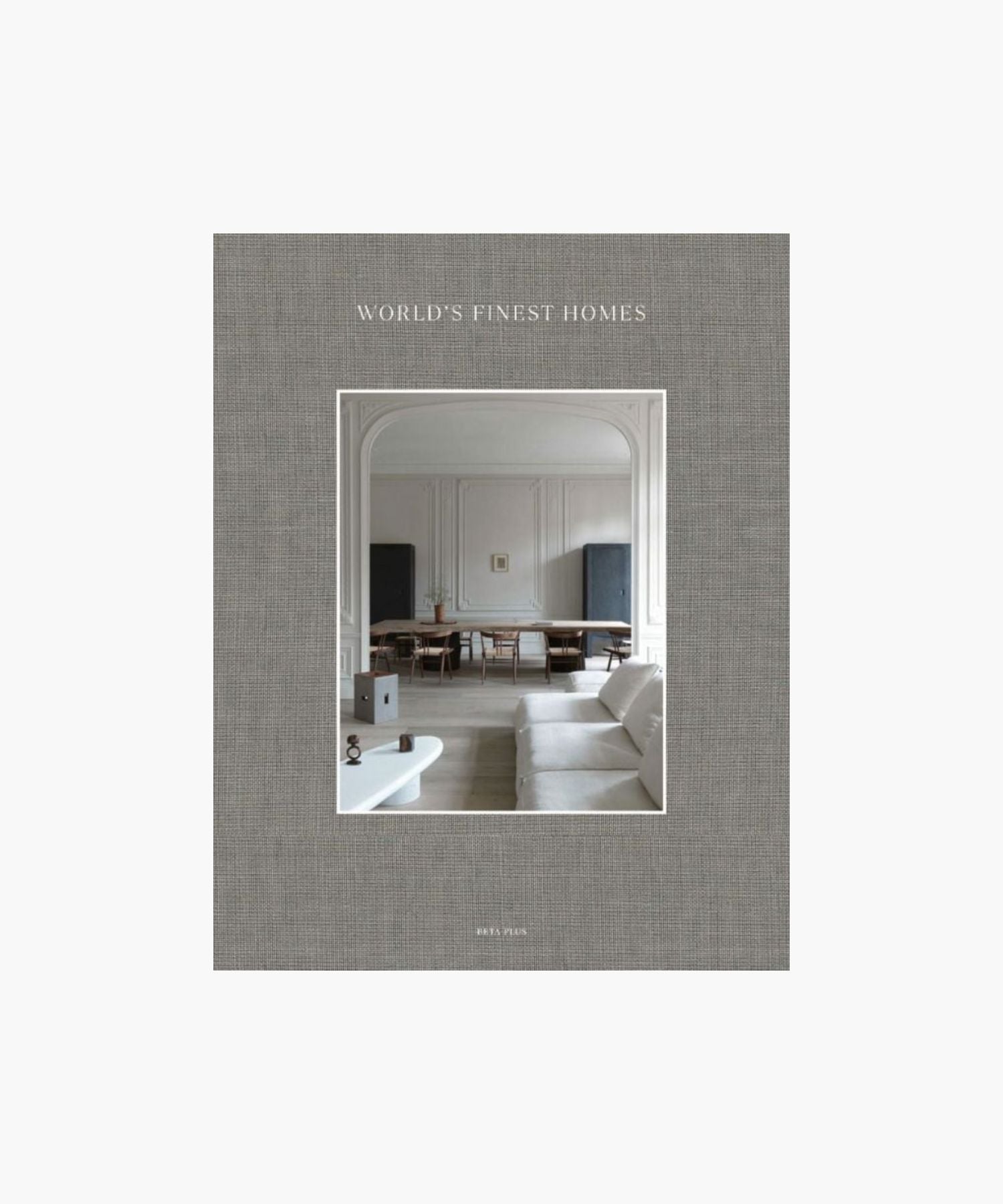 The cover of the book "World's Finest Homes" by Wim Pauwels features a minimalist living room. A neutral palette with a white sofa, elegant wood dining table, and soft lighting. | Wildwood Home Co.