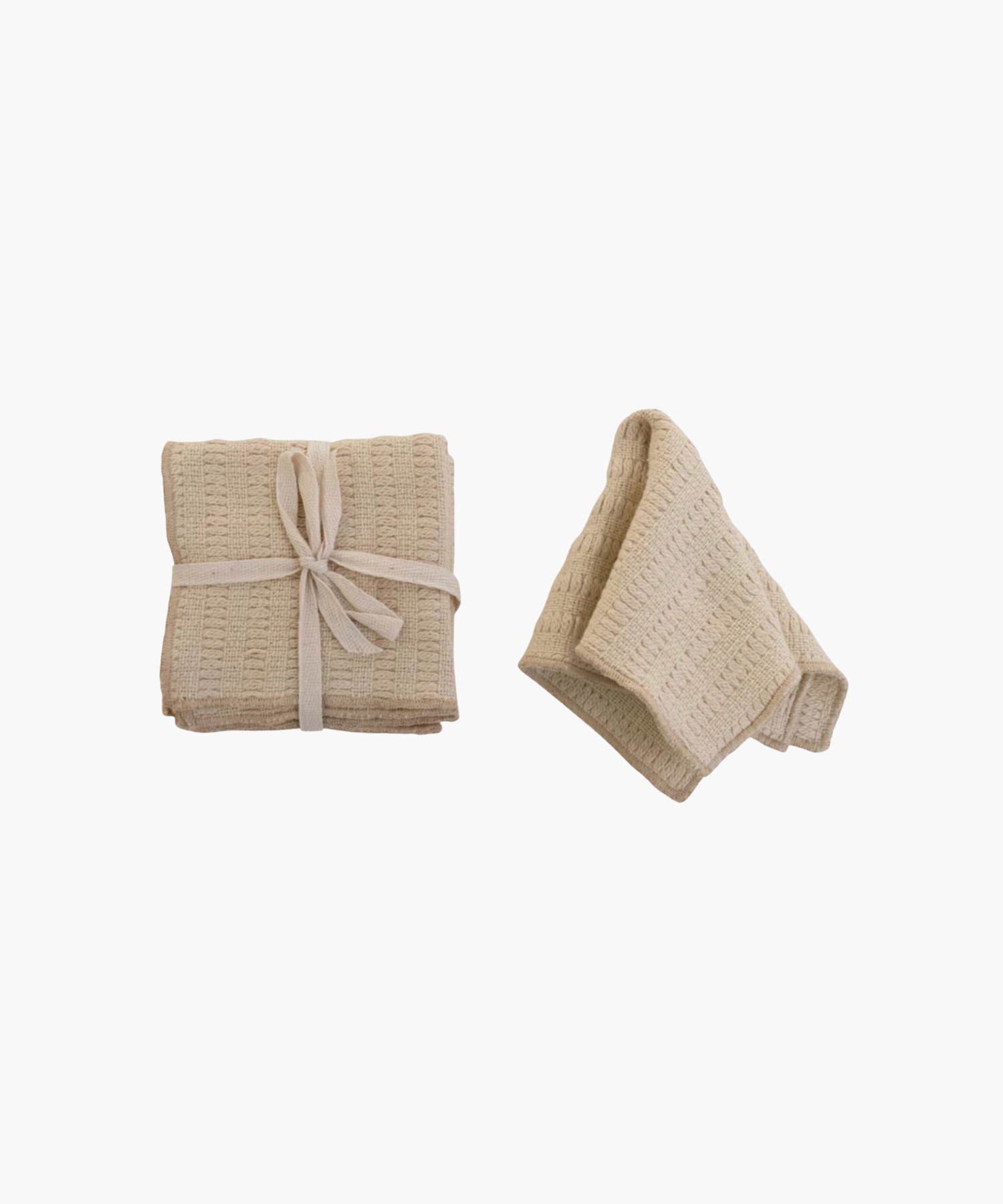Two ivory waffle-textured dish cloths; one folded and tied with a white ribbon, the other loosely folded. The tone is neutral and cozy. | Wildwood Home Co.