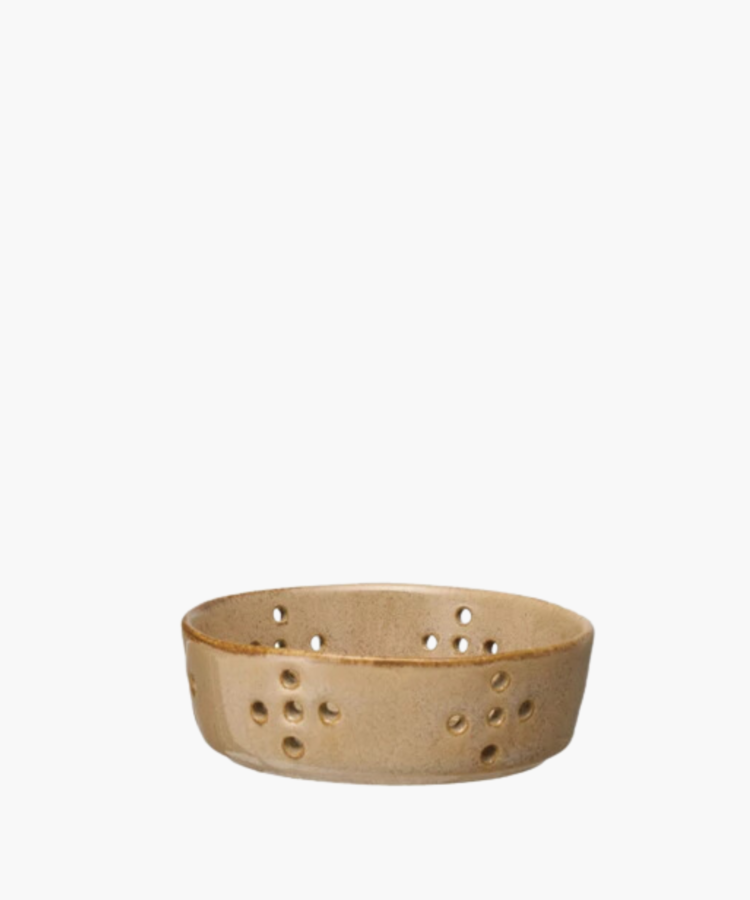 A beige ceramic colander features multiple circular drainage holes arranged in patterns. The bowl has a smooth, glazed finish, giving it a rustic appearance. | Wildwood Home Co.
