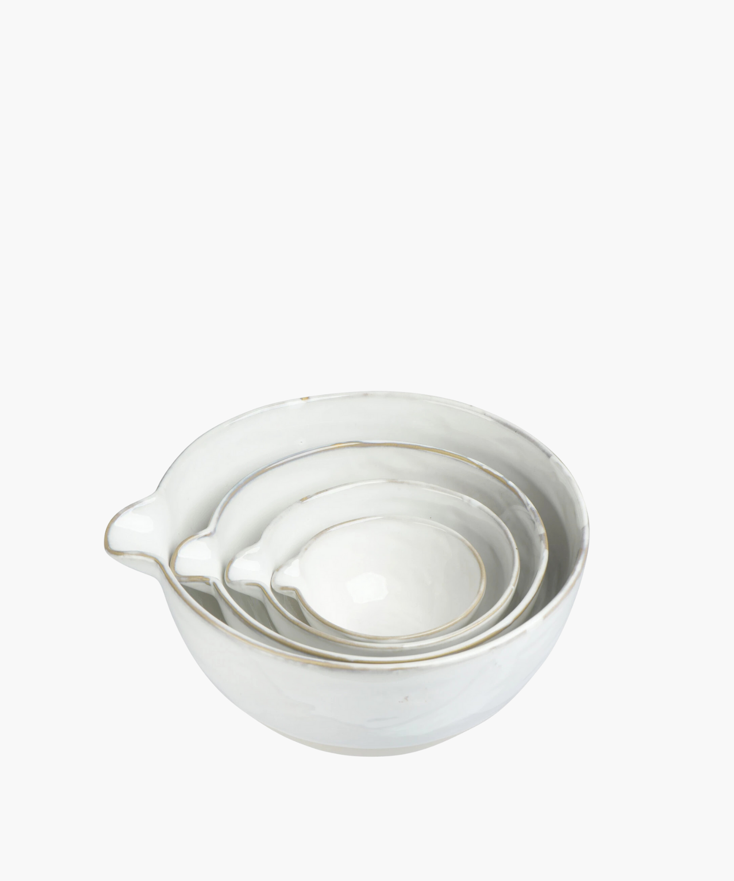 A set of four nested white ceramic bowls with subtle light grey accents, each equipped with a small pour spout, conveying elegance and simplicity. | Wildwood Home Co.
