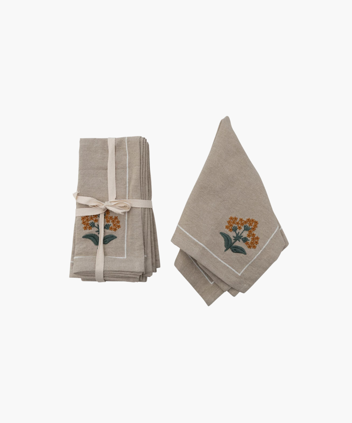 Two beige cloth napkins with orange floral embroidery. One stack is tied with a ribbon, the other folded open, suggesting elegance and simplicity. | Wildwood Home Co.