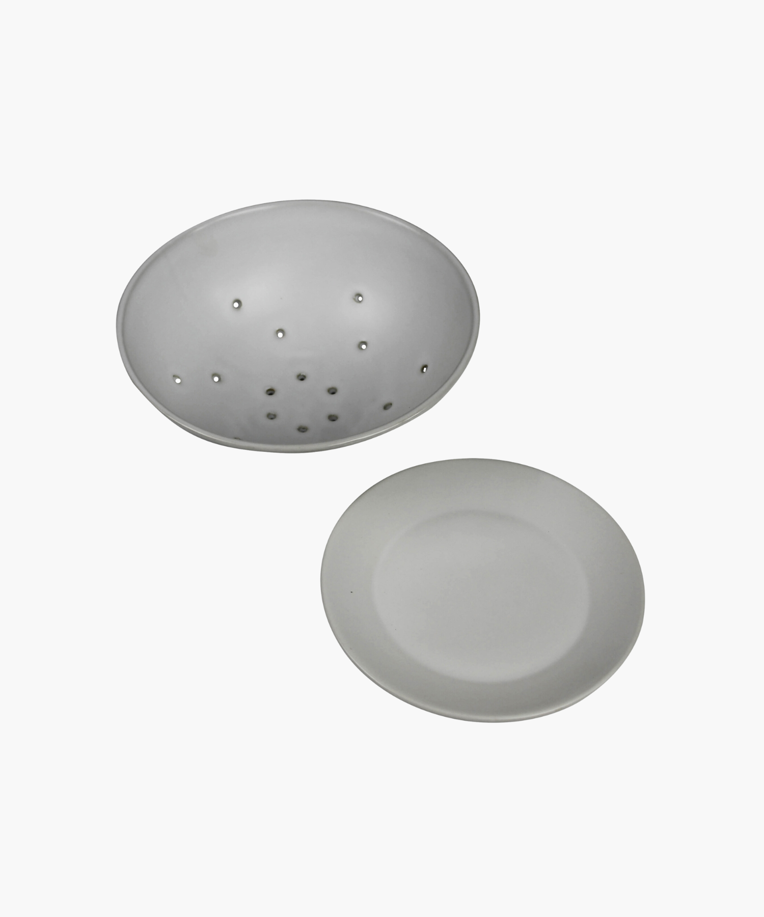 White ceramic colander with matching base plate. The minimalist design features a smooth matte finish, subtle curves, and small drainage holes. | Wildwood Home Co.