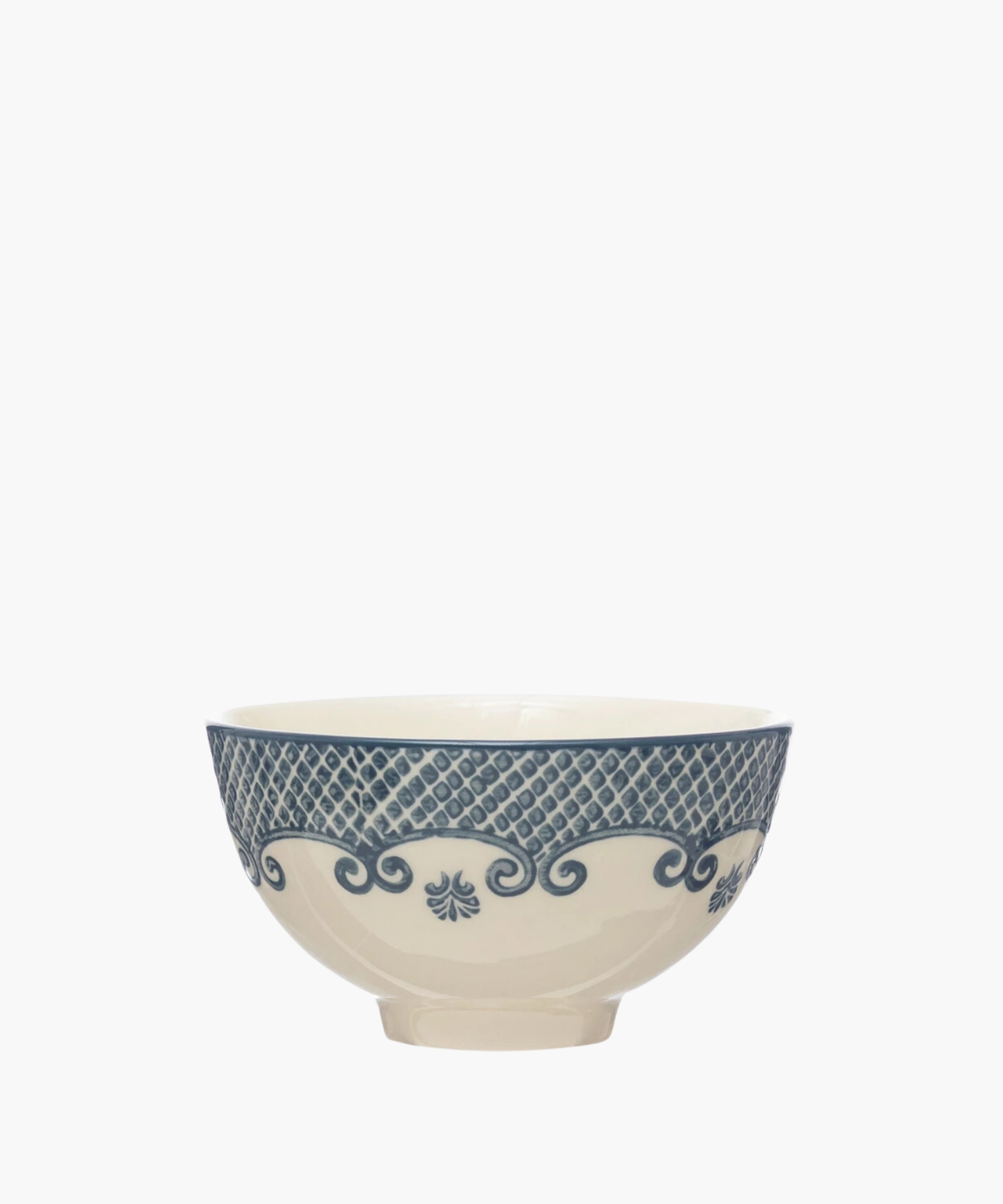 A cream-colored ceramic bowl with ornate blue patterns features lattice and swirl designs, conveying an elegant and vintage aesthetic. | Wildwood Home Co.