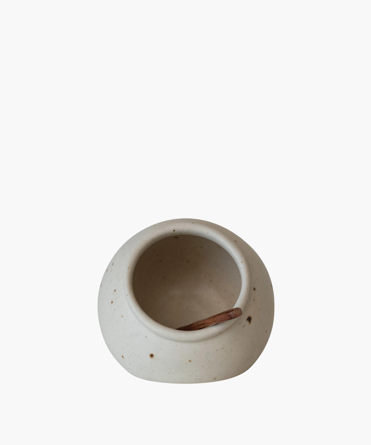 Creamy, speckled ceramic salt cellar with a small wooden scoop inside, evoking a rustic, minimalist aesthetic. The bowl's simple elegance suggests calm. | Wildwood Home Co.