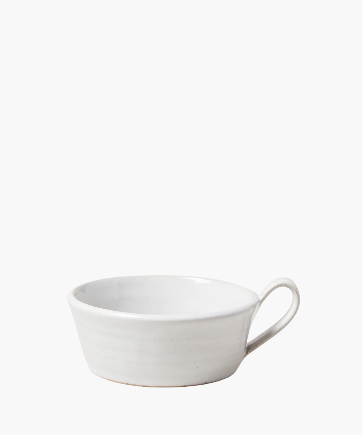 Simple white ceramic mug with a single loop handle on the right. The bowl has a smooth, matte finish and conveys a minimalist, elegant design. | Wildwood Home Co.