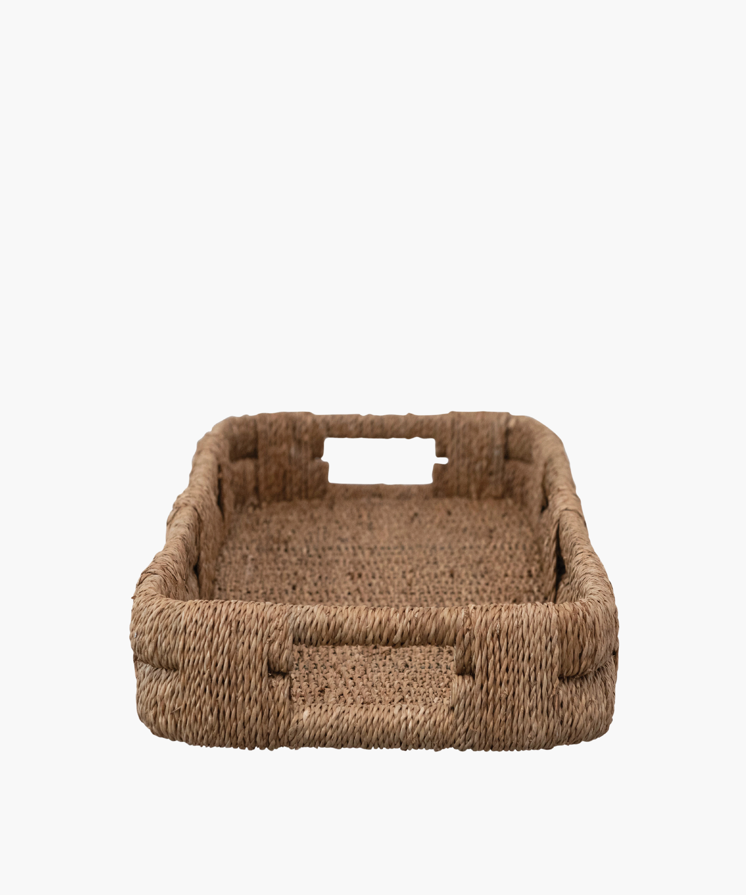 A long, rectangular woven wicker tray with short sides, displaying a natural brown color. It conveys a rustic, minimalist aesthetic.