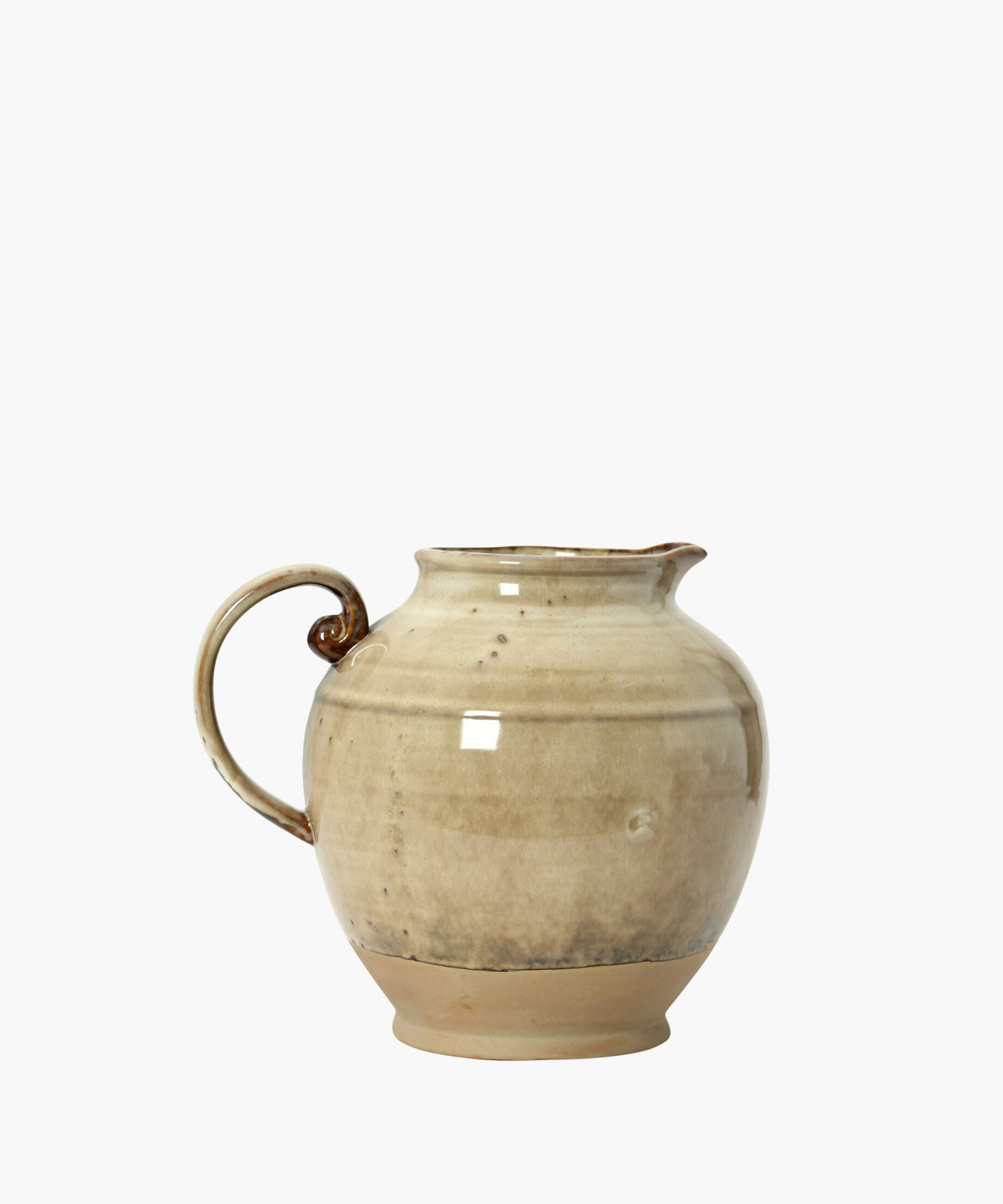 A beige ceramic pitcher with a rounded body, a curved handle, and a narrow spout. The glaze has subtle darker speckles, giving it a rustic feel. | Wildwood Home Co.