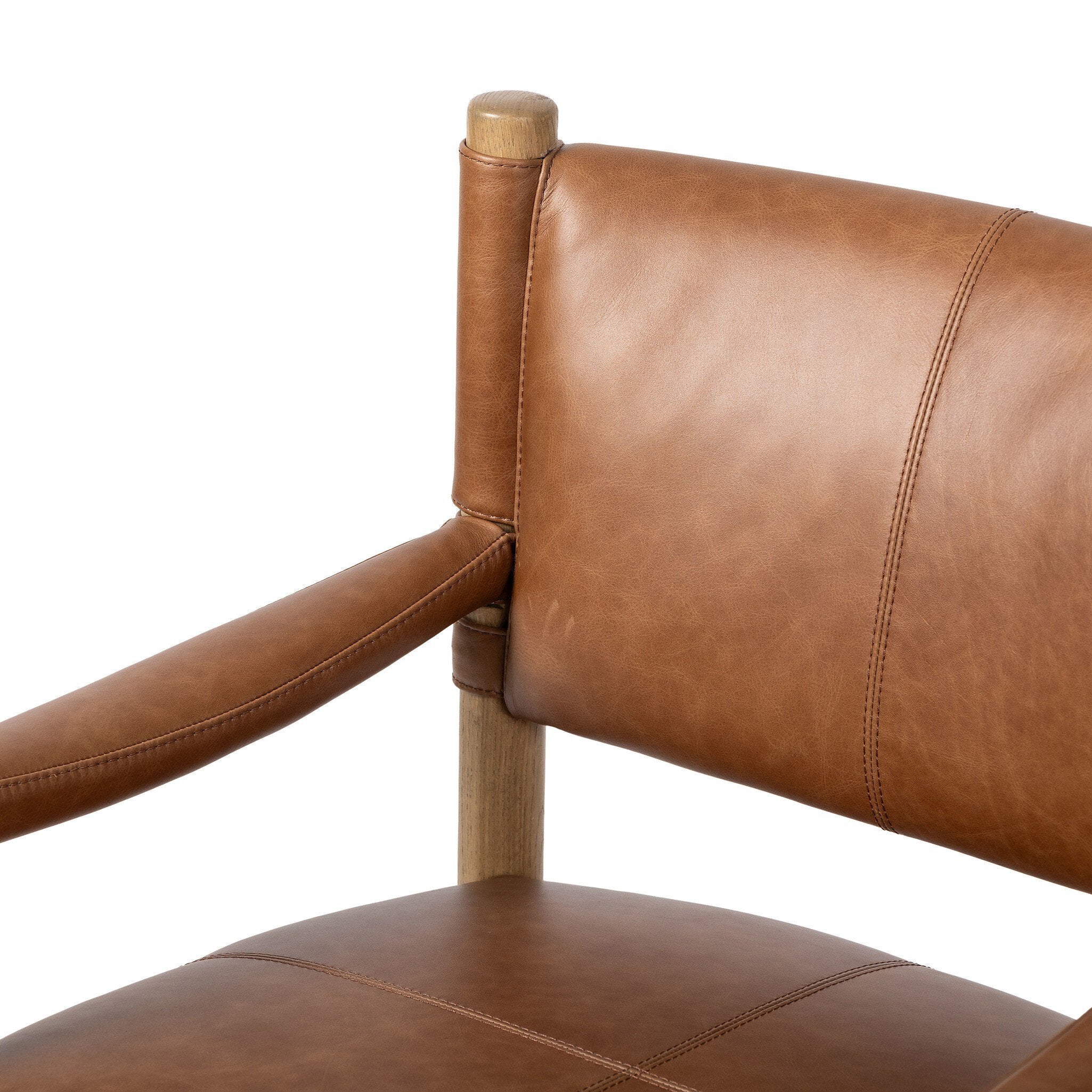 Brown leather dining armchair with wooden frame on a white background.