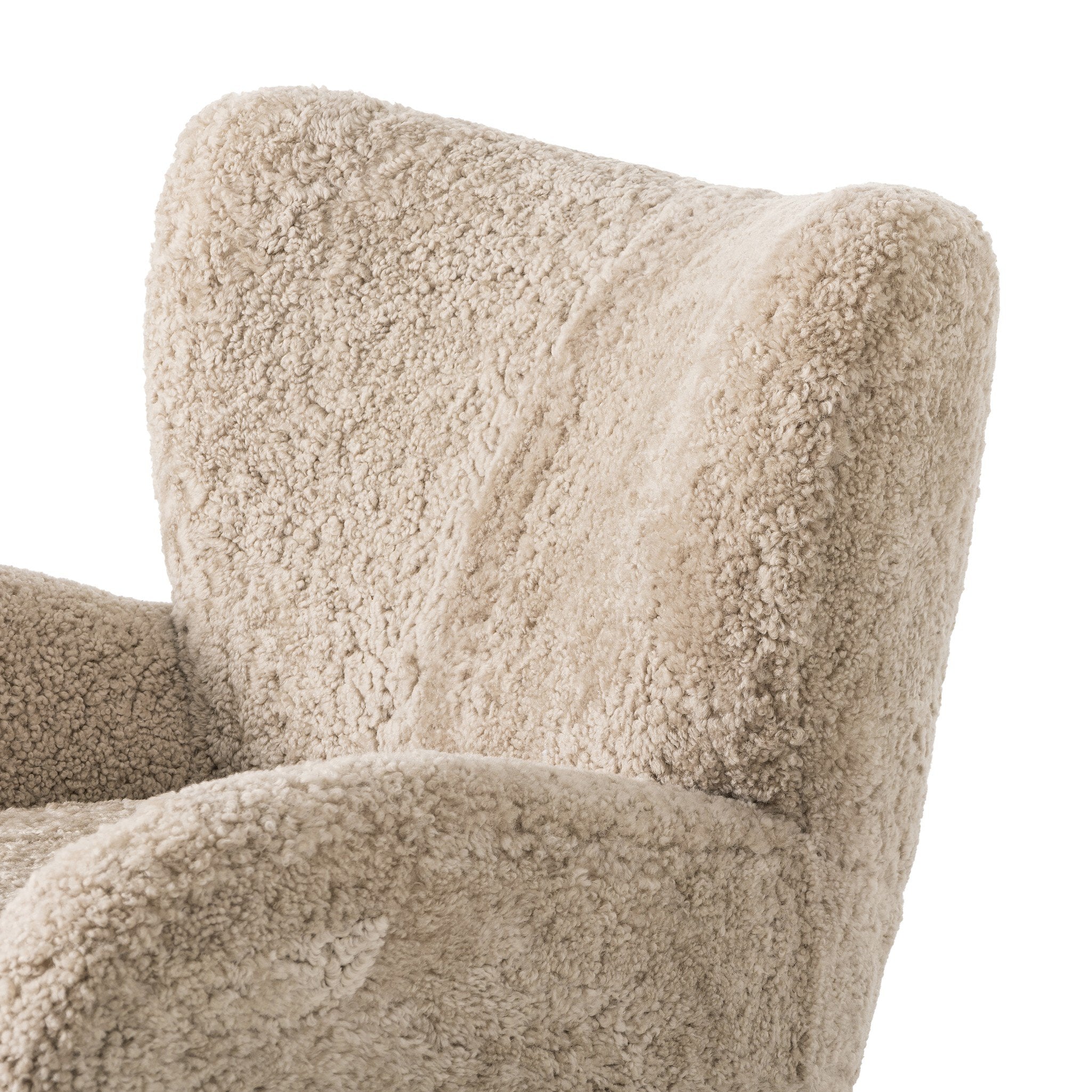 Close-up of a textured beige armchair on a white background