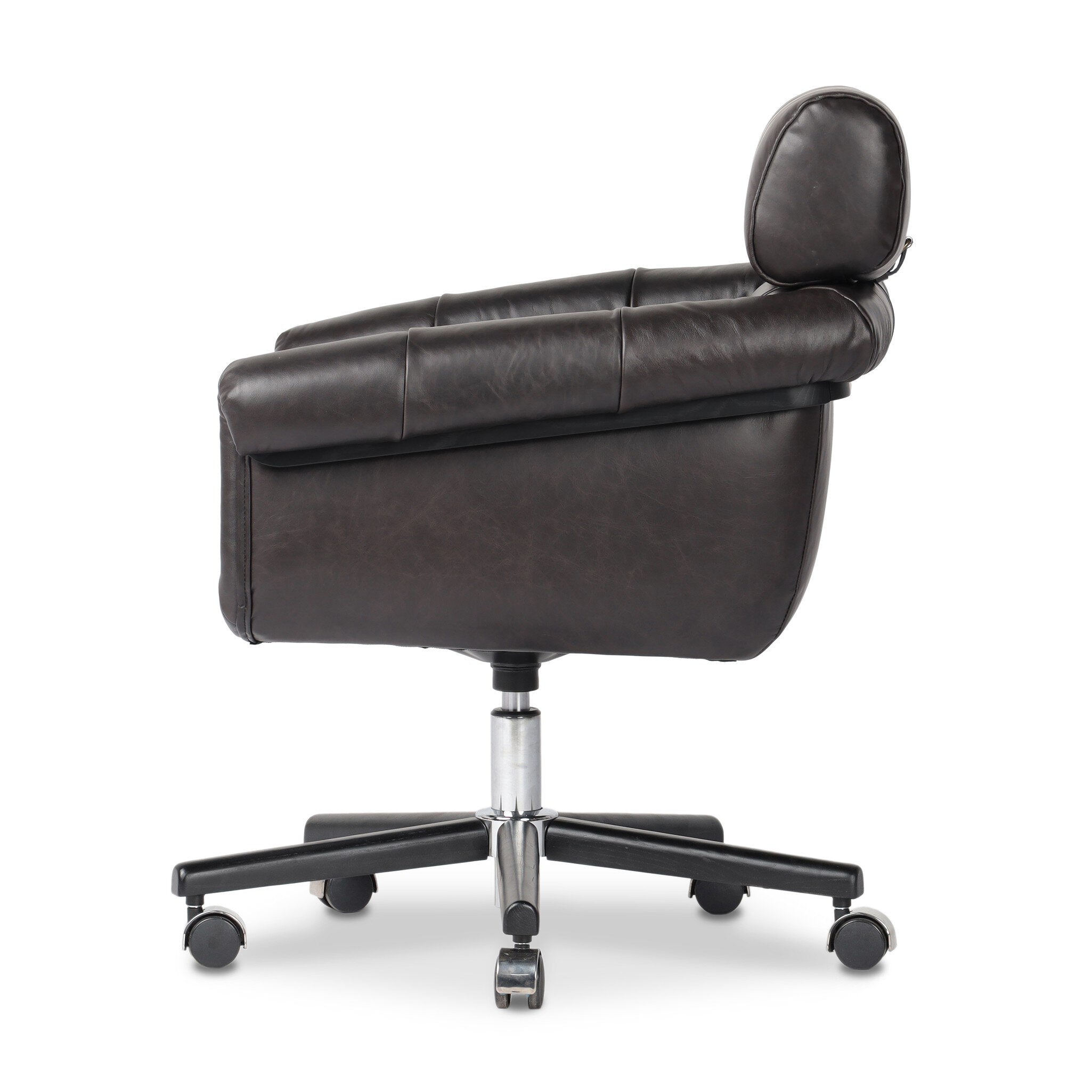 Tufted black leather desk chair with a chrome and black base on a white background. 