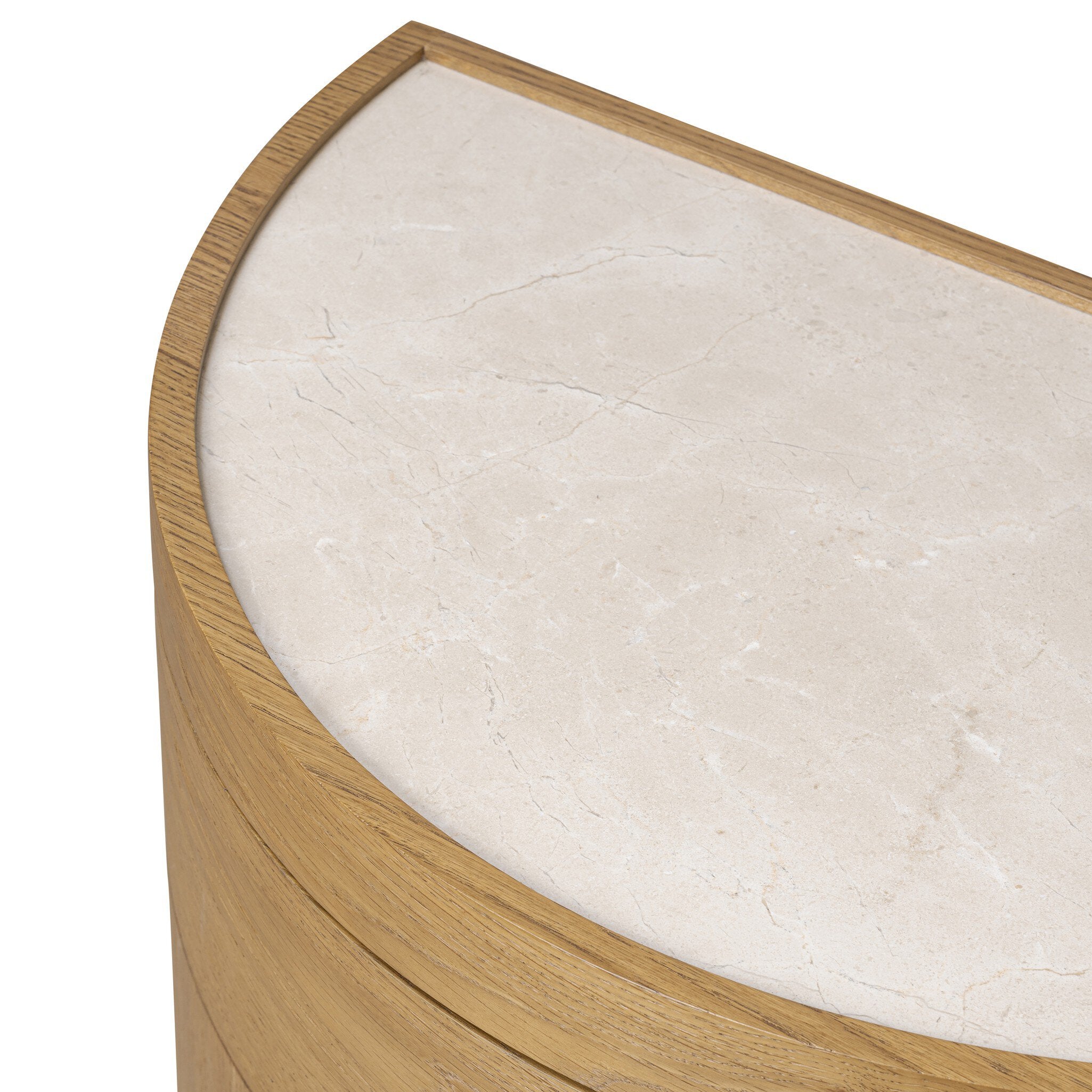 Overhead view of a crescent style night stand with doors and cream marble top. 