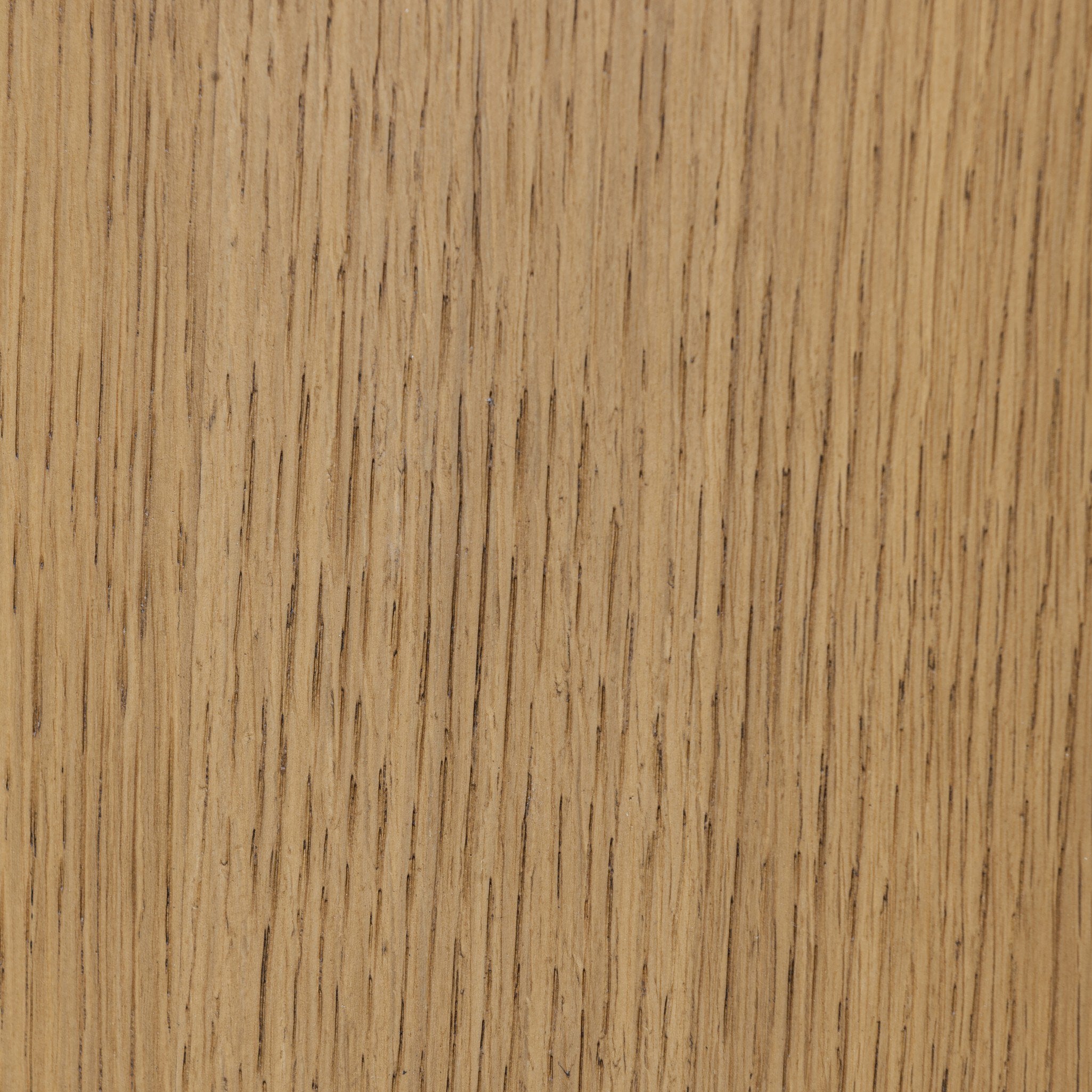 Close up of the oak veneer on the nightstand showing its coloring and graining. 