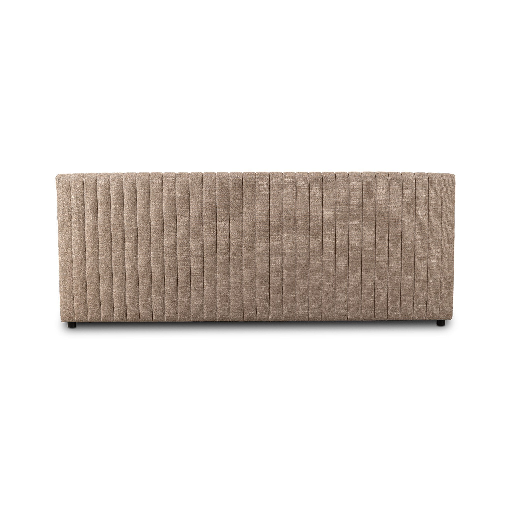 The back of a taupe dining banquette with quilted texture on a white background. 