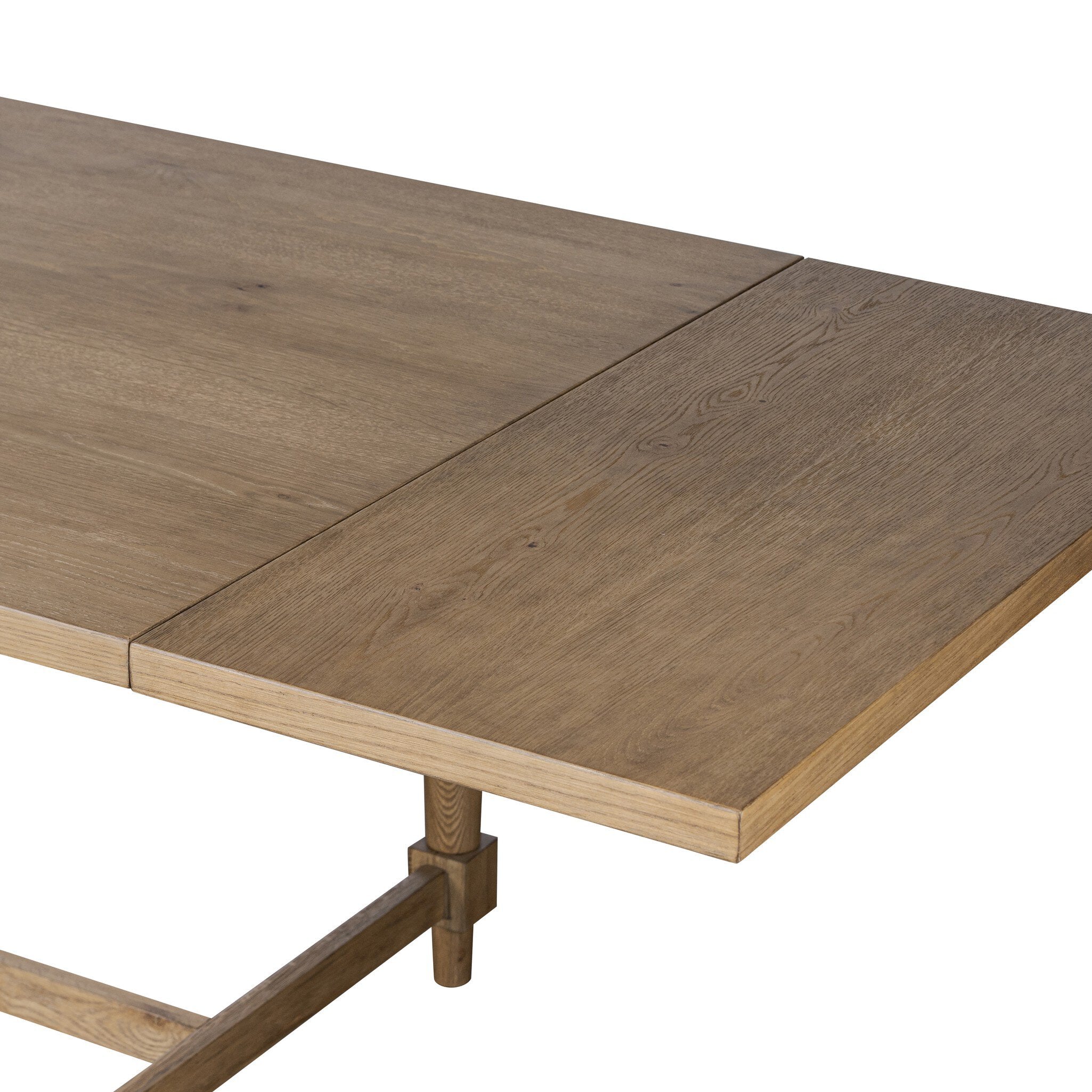 Close up of a rectangular wood dining table on a white background.