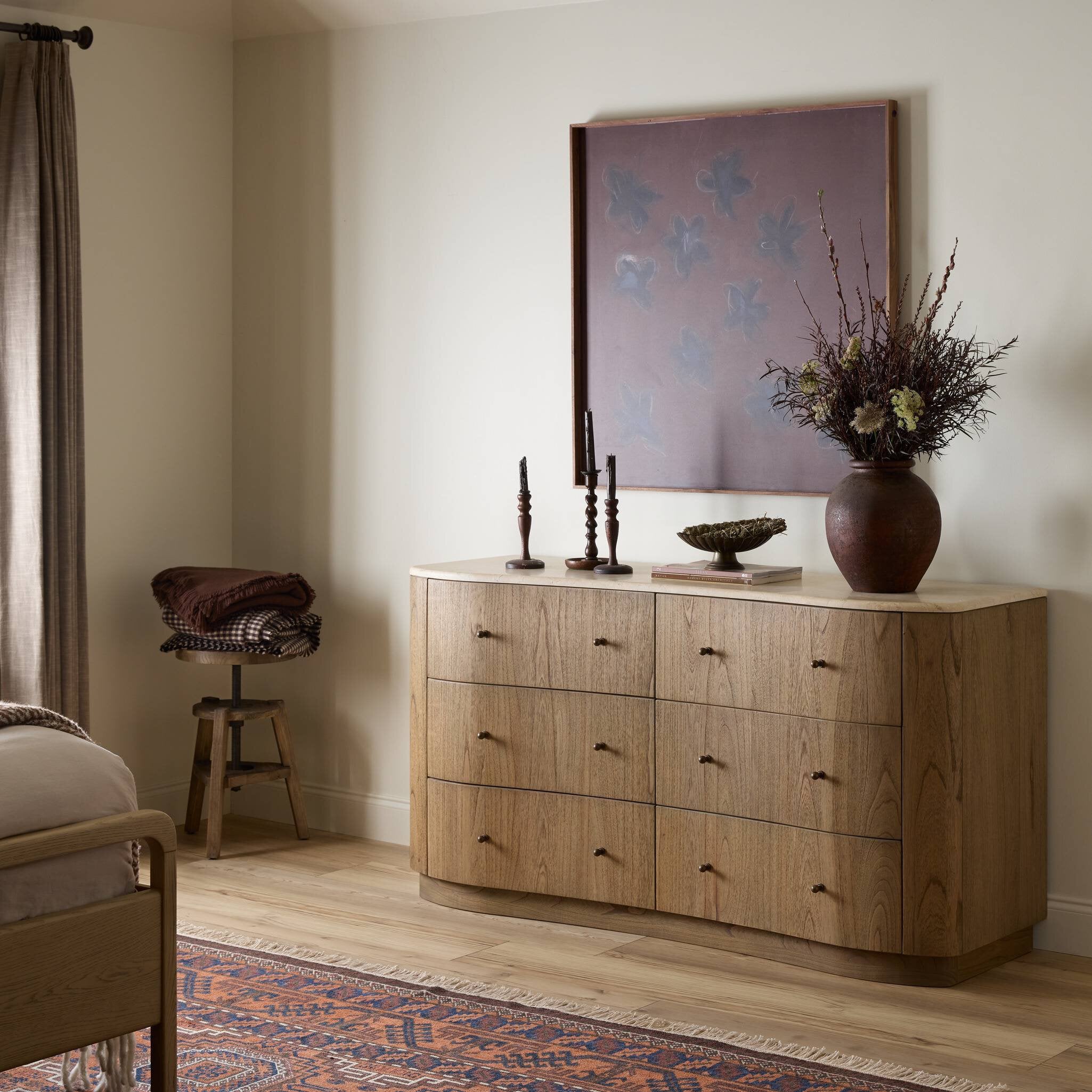 Wooden dresser with decorative items in a bedroom setting. | Wildwood Home Co.