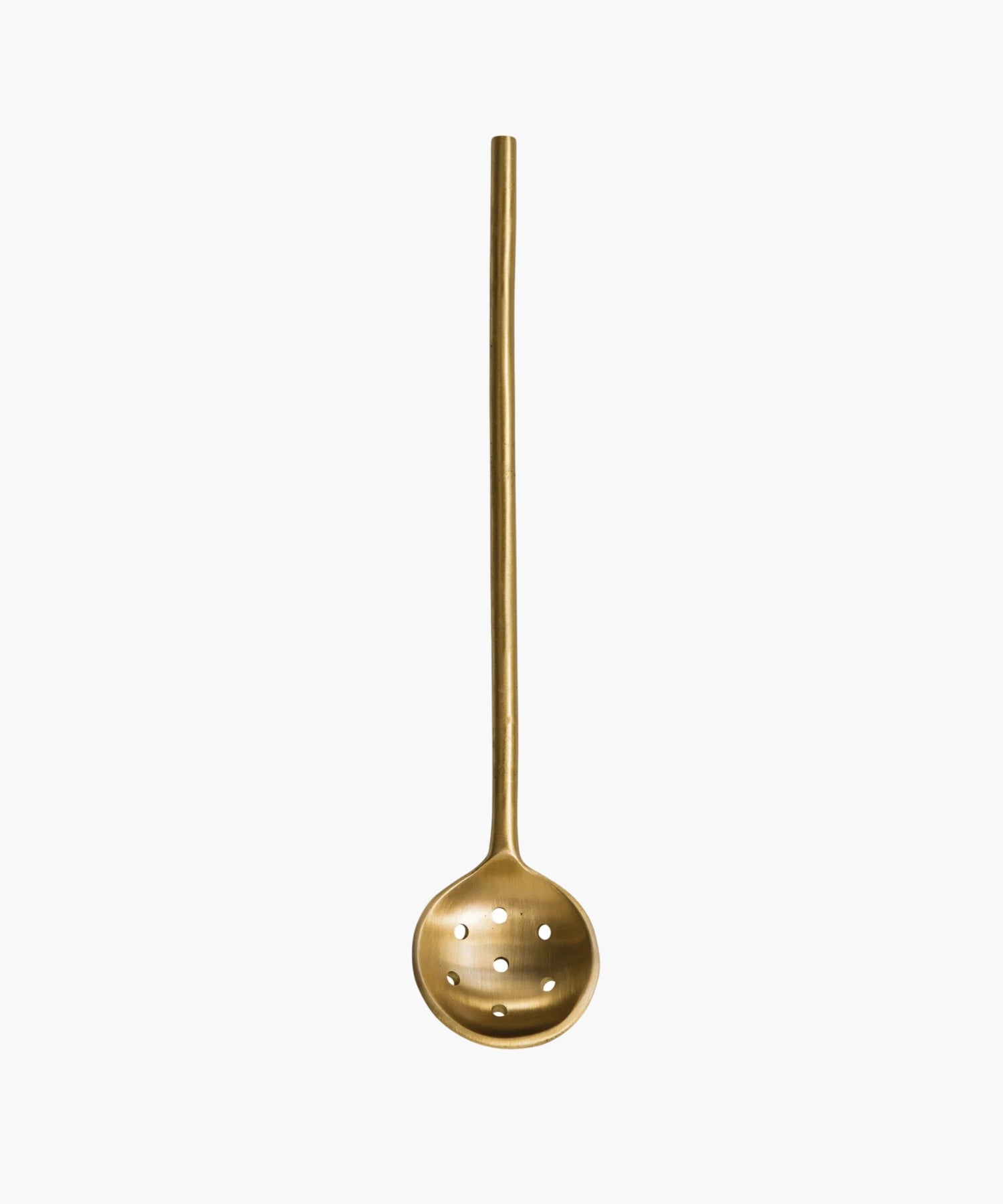 A minimalist brass slotted spoon with a long handle and round, perforated ladle, evoking elegance and simplicity. | Wildwood Home Co.