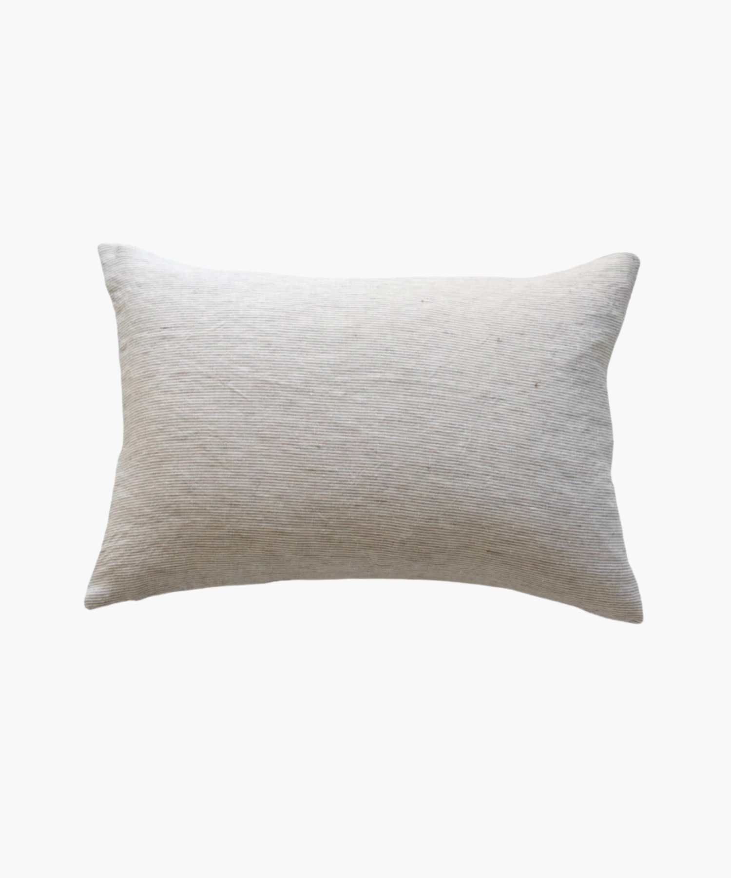 A rectangular lumbar, light beige pillow with a textured fabric surface is shown against a plain white background. The pillow has a soft, minimalist feel. | Wildwood Home Co.
