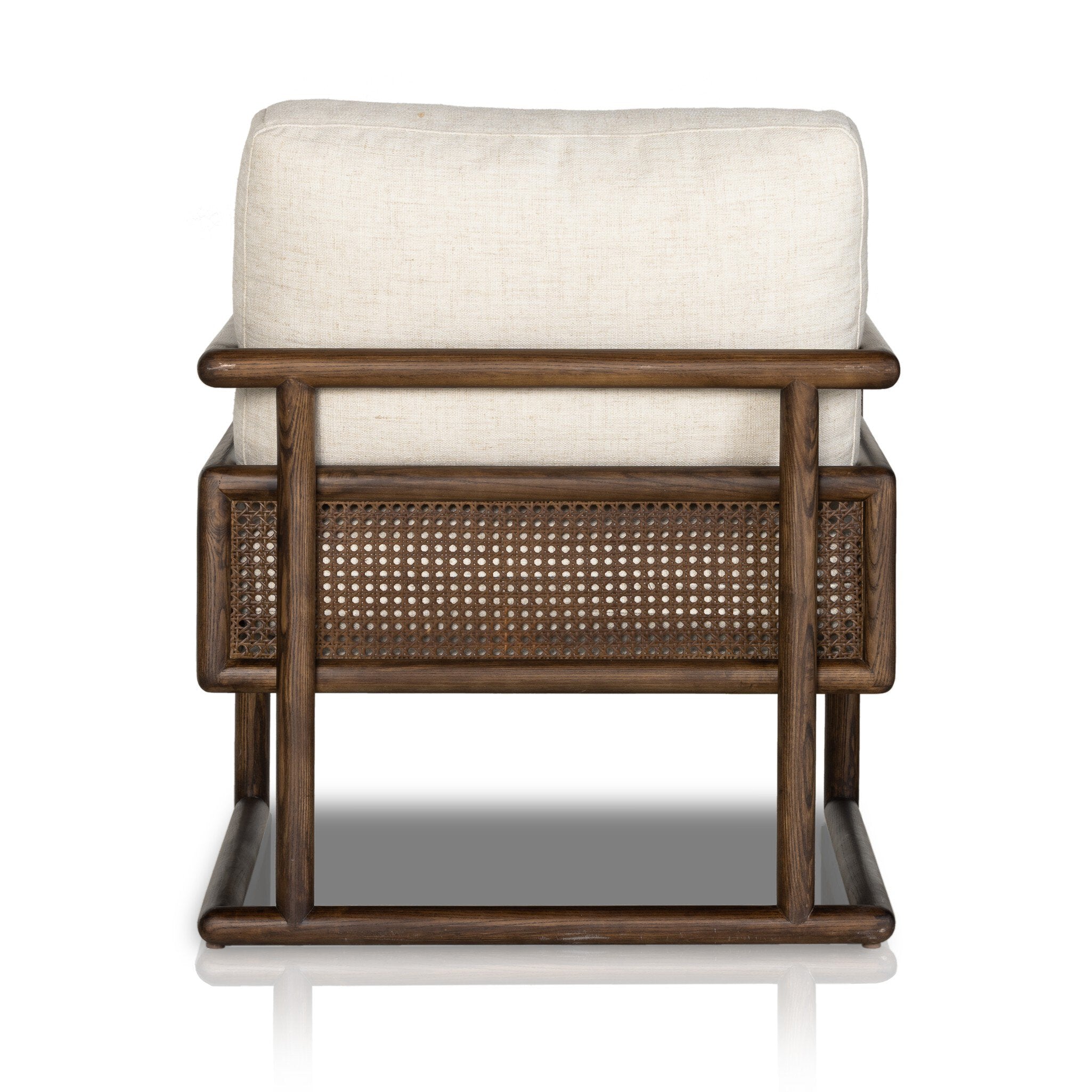 The back of chair with neutral linen fabric, cane panels with open rounded framing.