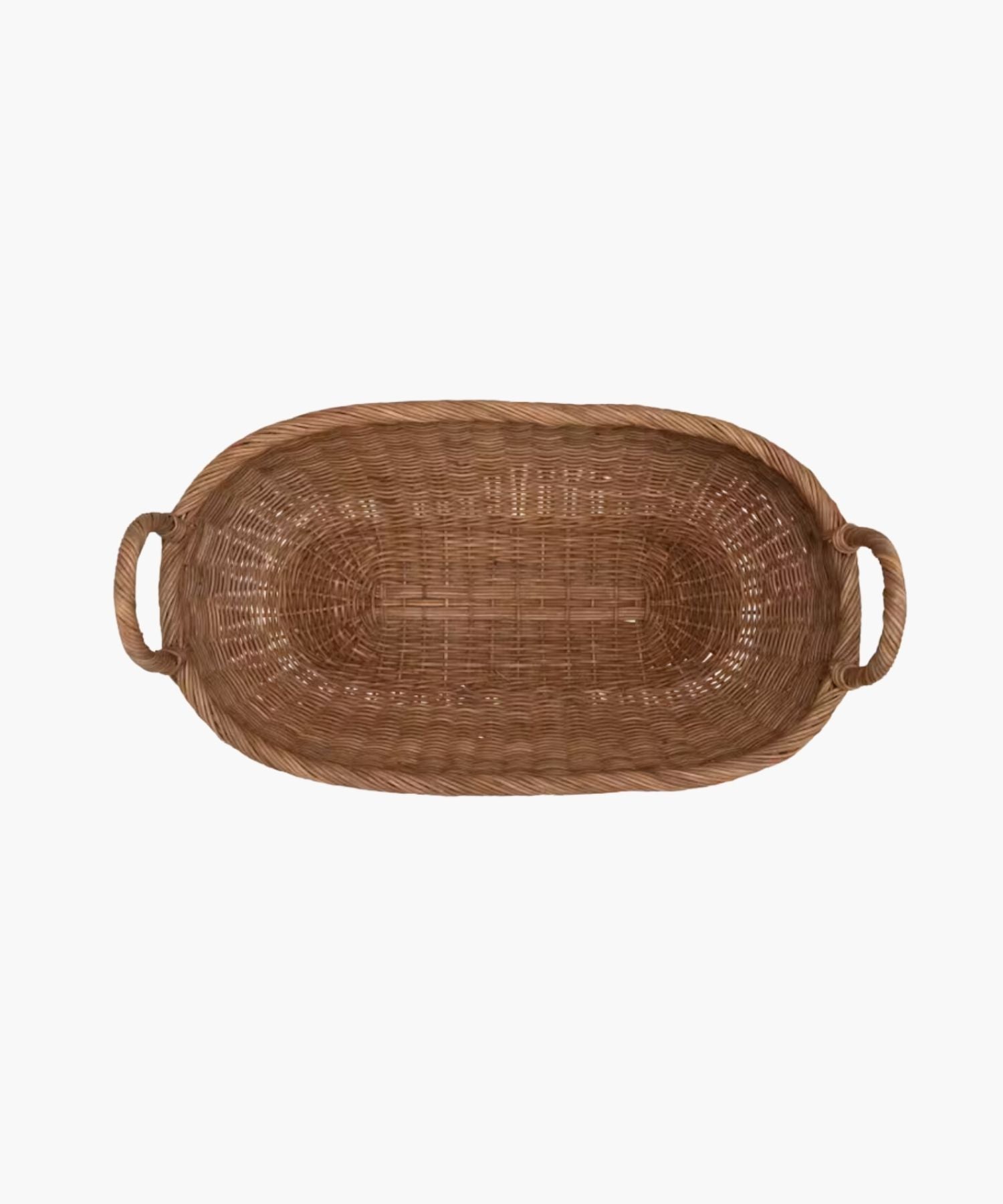 Overhead view of a handwoven wicker basket with two looped handles on either side featuring an organic oval shape and a natural brown finish. The basket has a natural, rustic appearance. | Wildwood Home Co.