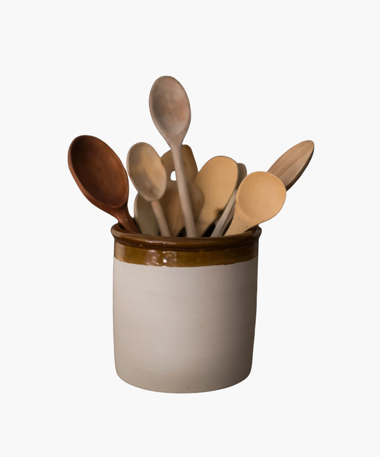 A ceramic crock holds various wooden spoons with different shades and shapes. The combination of natural tones adds a rustic and cozy atmosphere. | Wildwood Home Co.