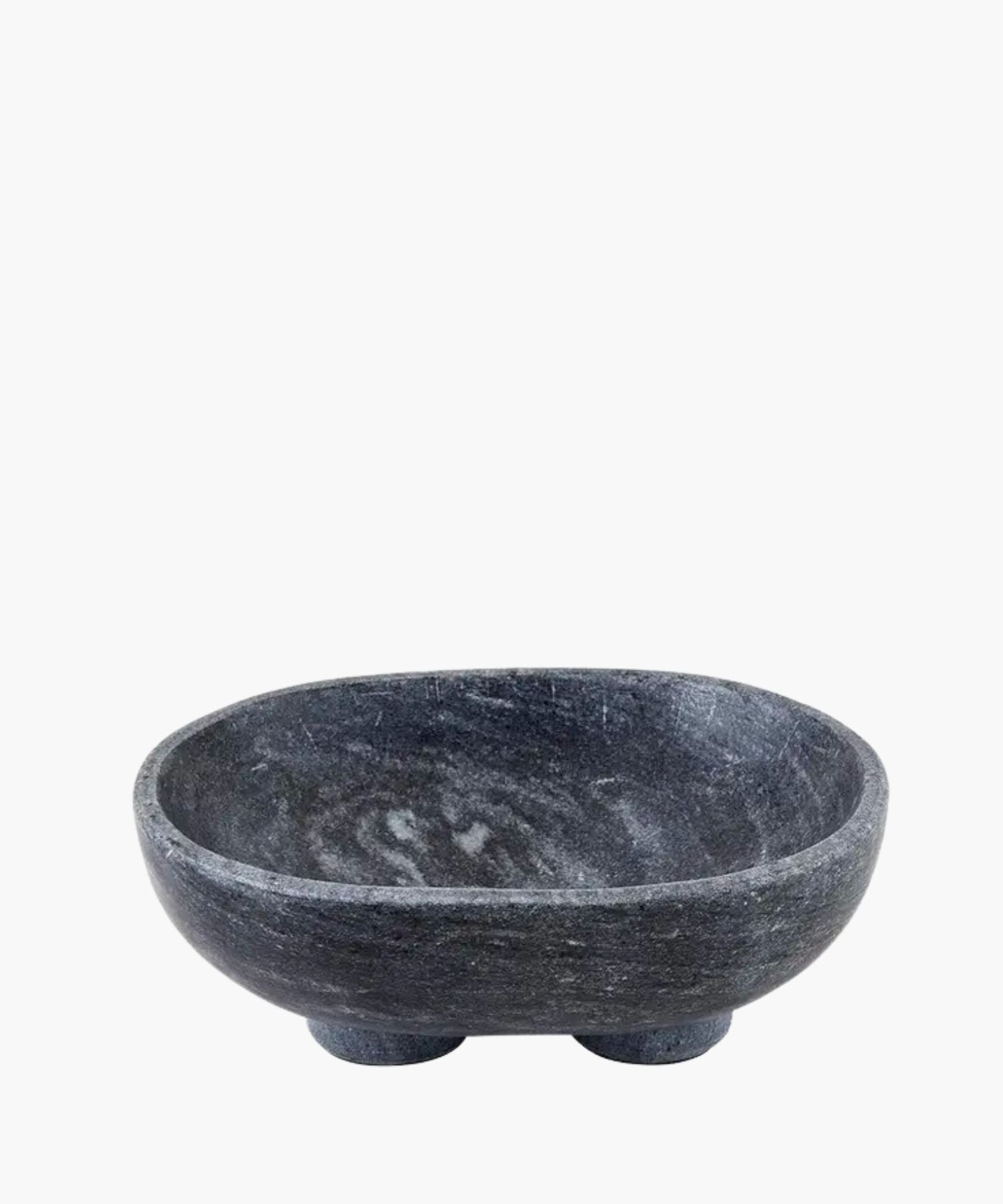 A smooth, dark charcoal gray marble bowl with subtle white veining, sits on two rounded feet. The bowl has a minimalist and modern design. | Wildwood Home Co.