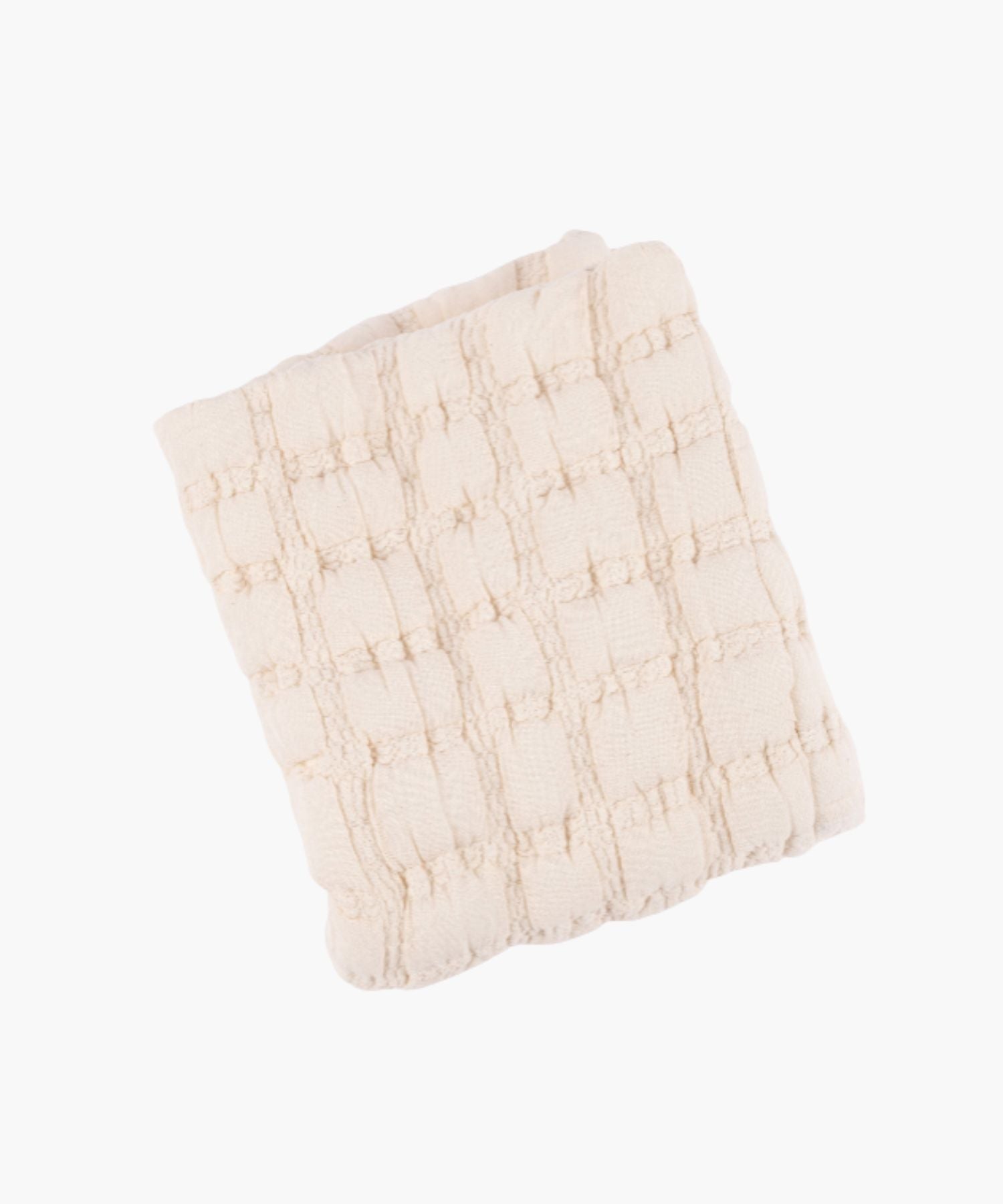 Folded view of a cream quilt with a soft, puffed grid texture and subtle stitched detailing. | Wildwood Home Co.
