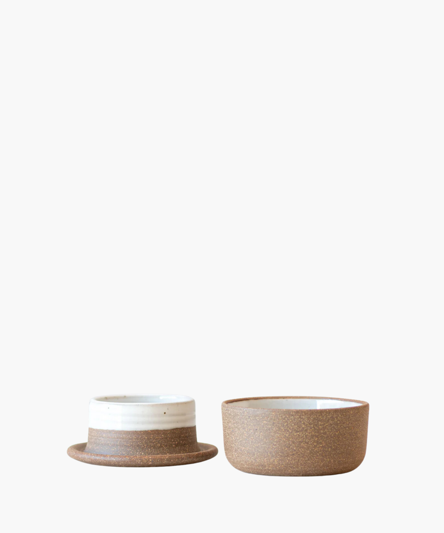 Ceramic butter keeper with minimalist design. The left is shorter with a wider rim and white top band. The right is taller, plain brown, on a white background. | Wildwood Home Co.