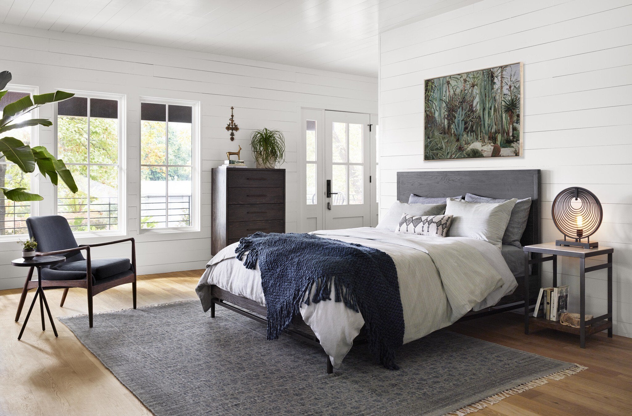 Modern bedroom with a bed, nightstands, and decor elements.