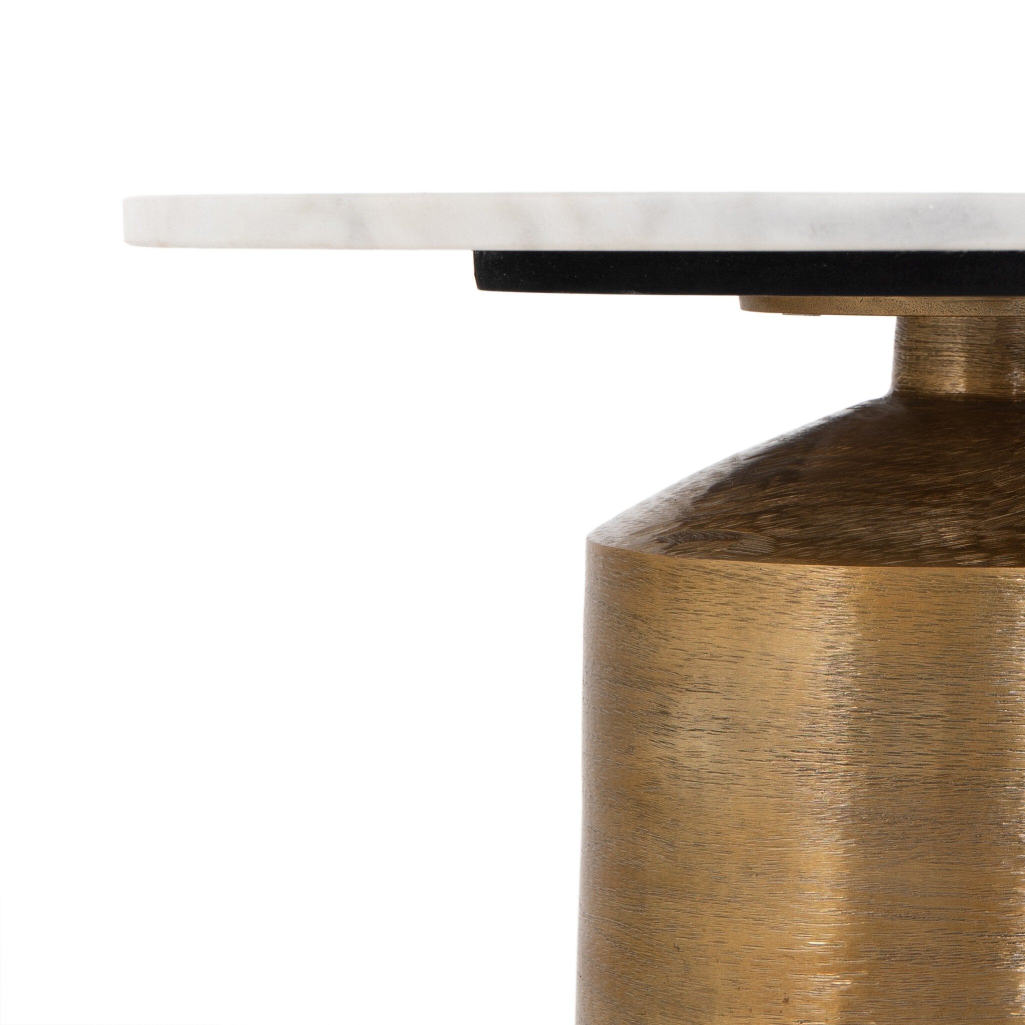 Close-up of a table with a marble top and brass base on a white background. | Wildwood Home Co.