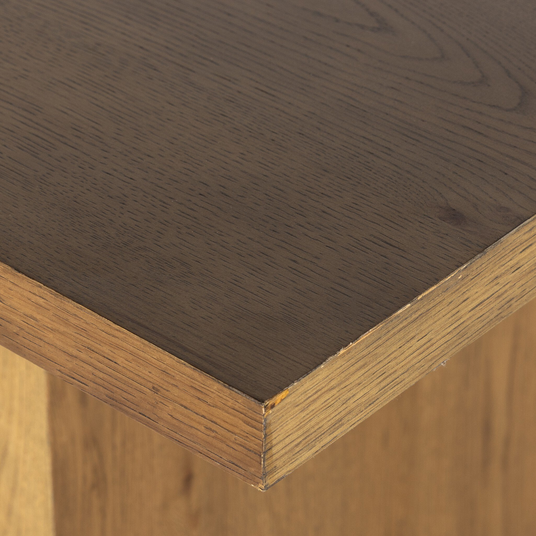 Close up of a wood dining table on a white background.
