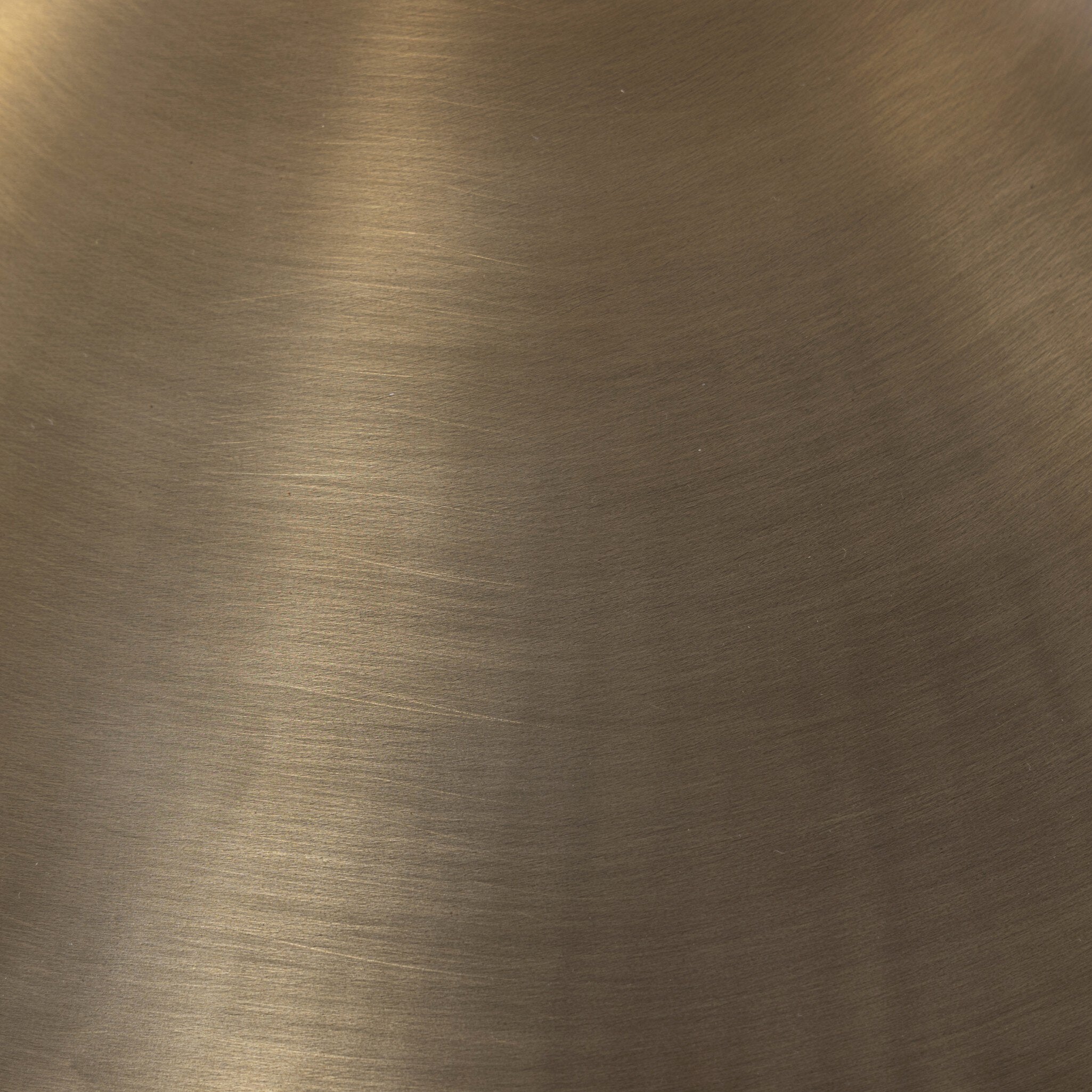 Close-up of the brass lamp shade of the floor lamp showing its color and texture. 