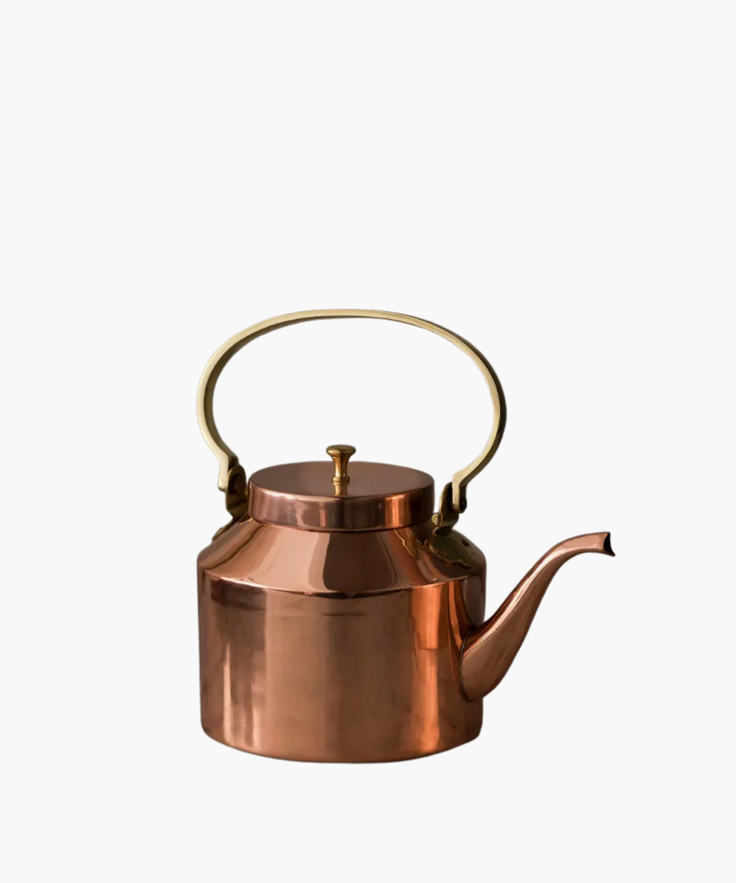 Copper tea kettle with a shiny finish and a curved spout. It features a round, gold-colored handle and lid, reflecting a classic, elegant design.
