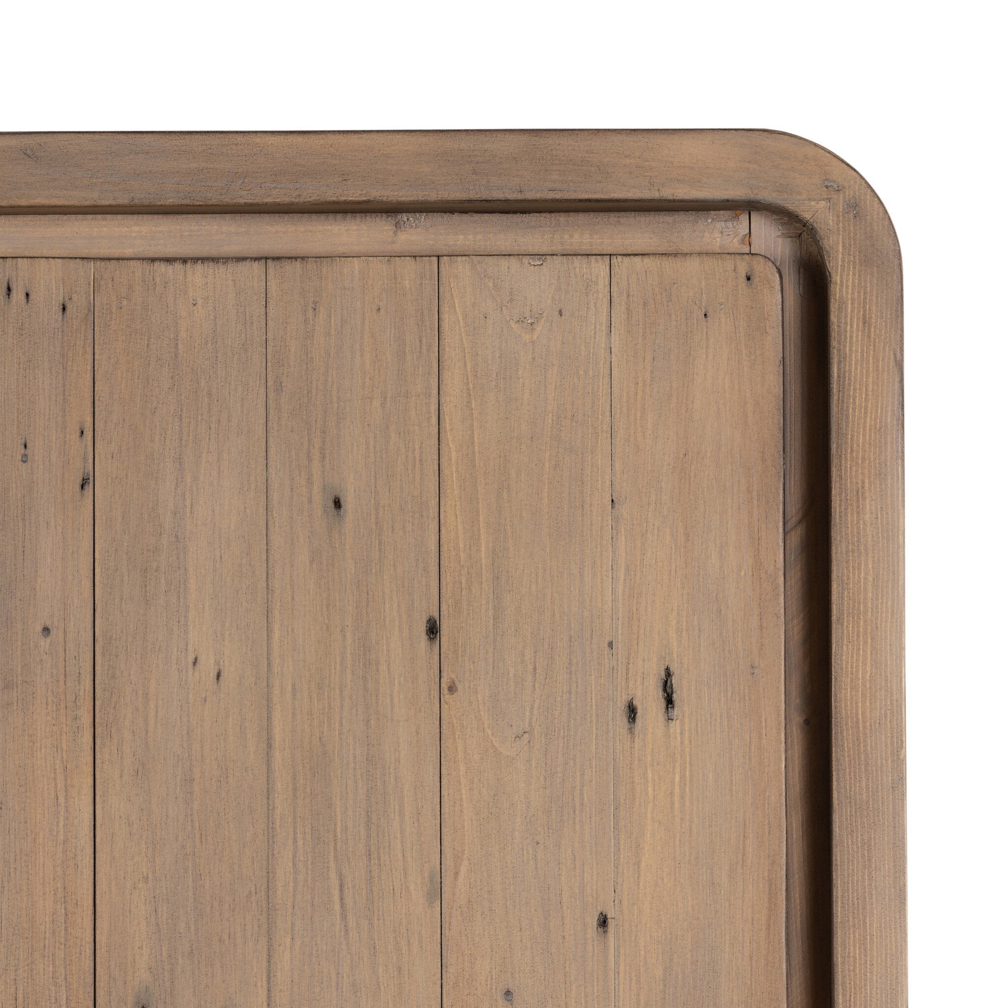 Close up of a wooden cabinet with two doors and rounded corners on a white background.