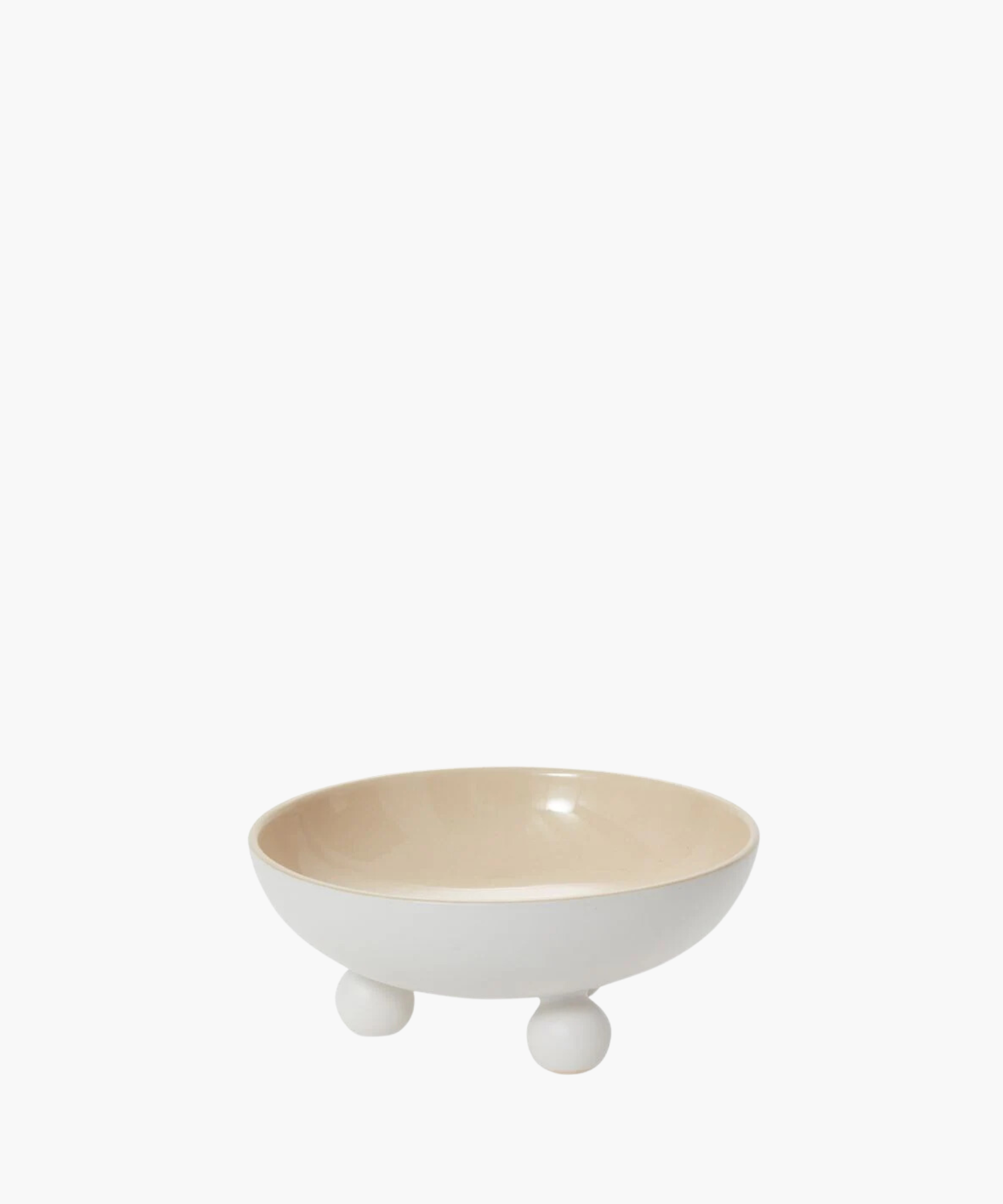 A minimalist white ceramic bowl with a smooth, glossy finish sits on three round feet. The interior is a light beige, conveying simplicity and elegance. | Wildwood Home Co.