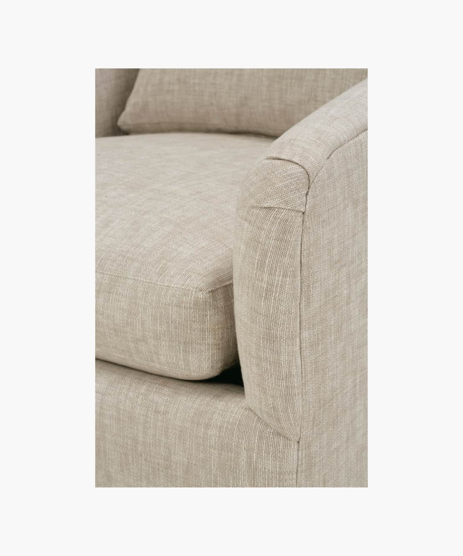 Close up of a beige armchair on a white background.