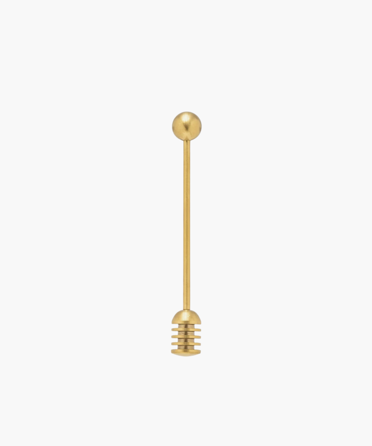 Gold honey dipper with a round handle and grooved end for collecting honey, set against a plain white background. Simple and elegant kitchen tool. | Wildwood Home Co.