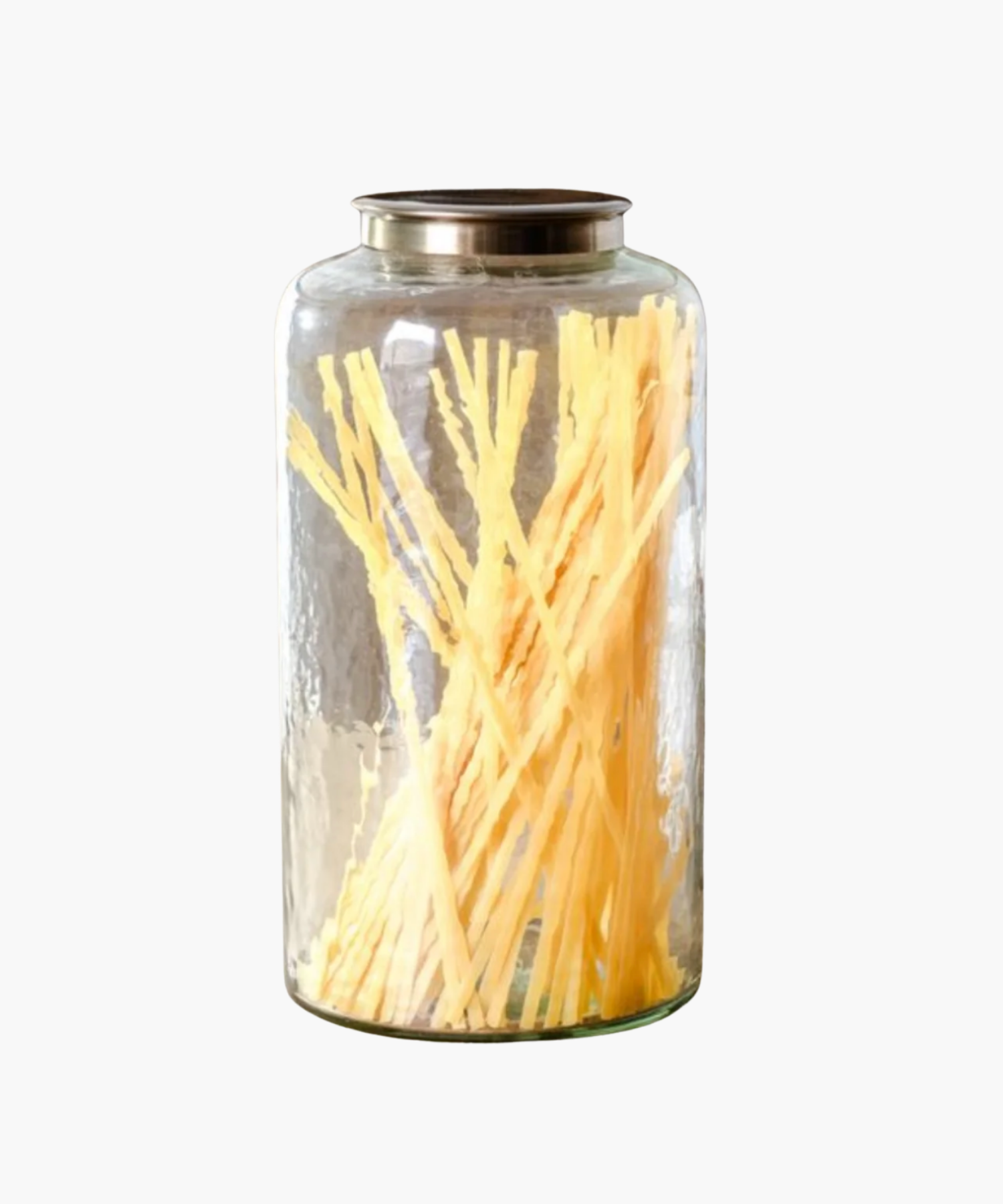 A tall transparent glass jar with a metallic lid, containing a dried spaghetti. The jar exudes a minimalist and rustic vibe. | Wildwood Home Co.