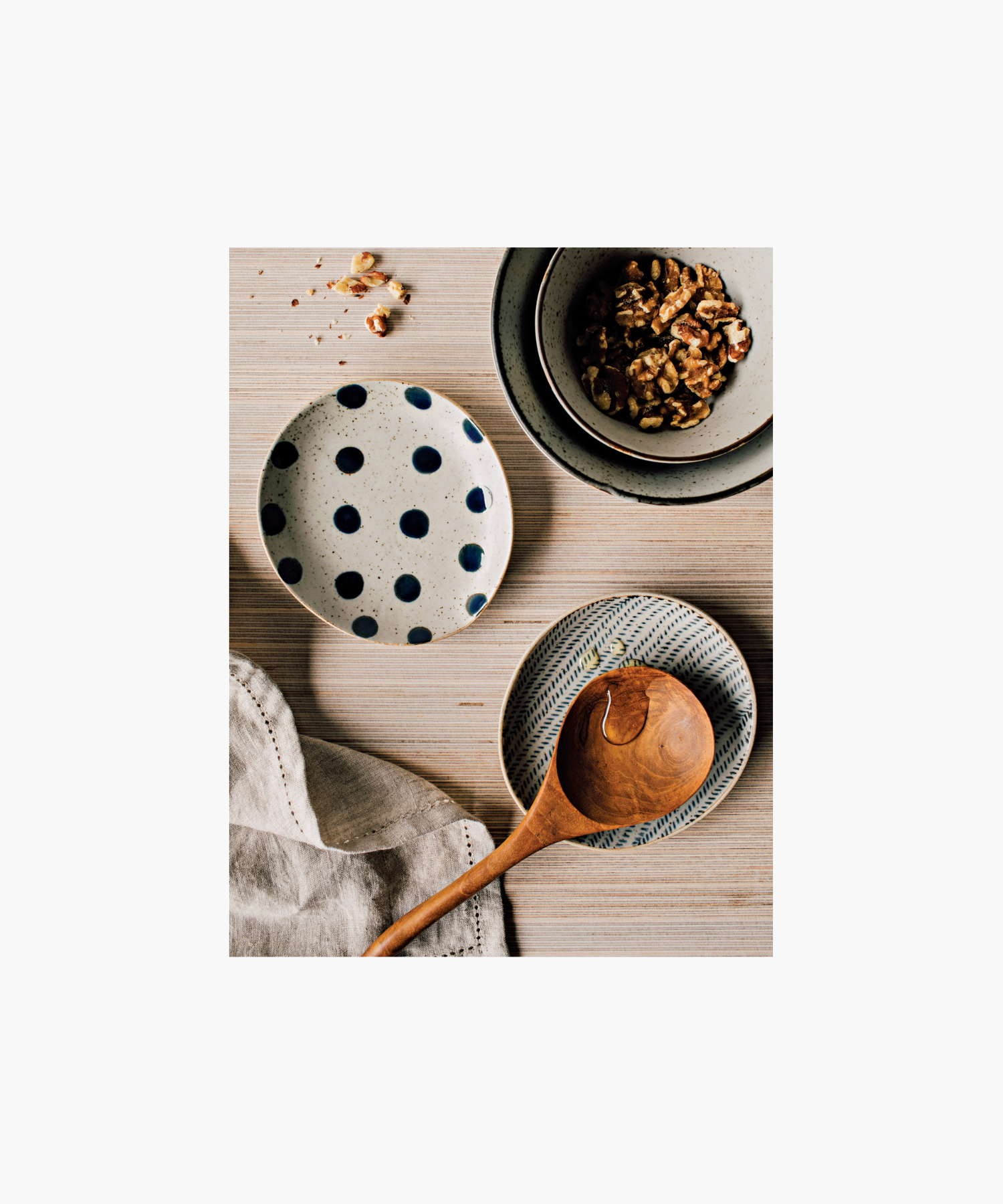 Round ceramic spoon rest with a diagonal blue herringbone pattern on a white background style with other kitchen serveware. The design is symmetrical, creating an elegant, minimalist look. | Wildwood Home Co.