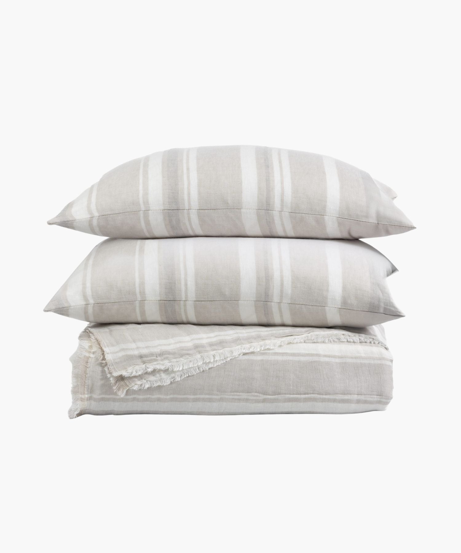 Stacked view of coverlet and shams in a soft taupe and white stripe pattern with fringe edge detail, highlighting its light texture. | Wildwood Home Co.
