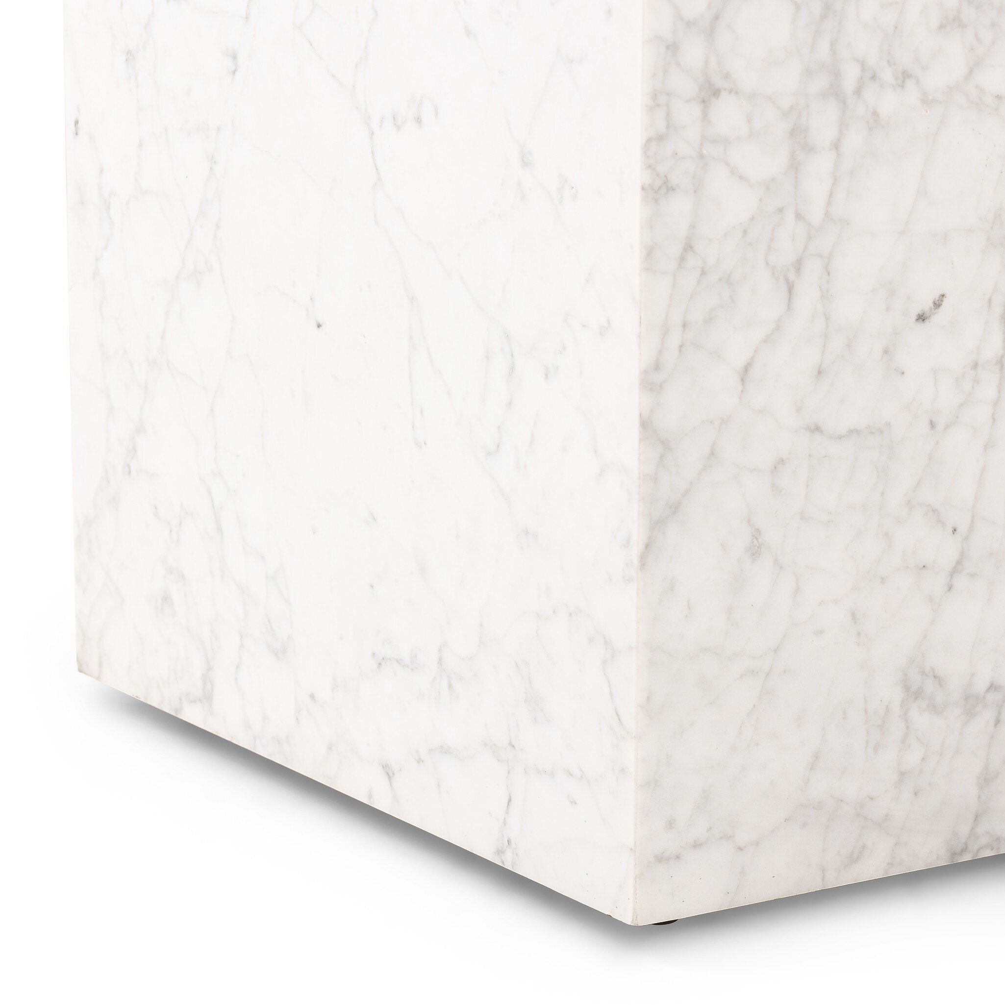 Close up of a Carrara marble square end table on a white background.