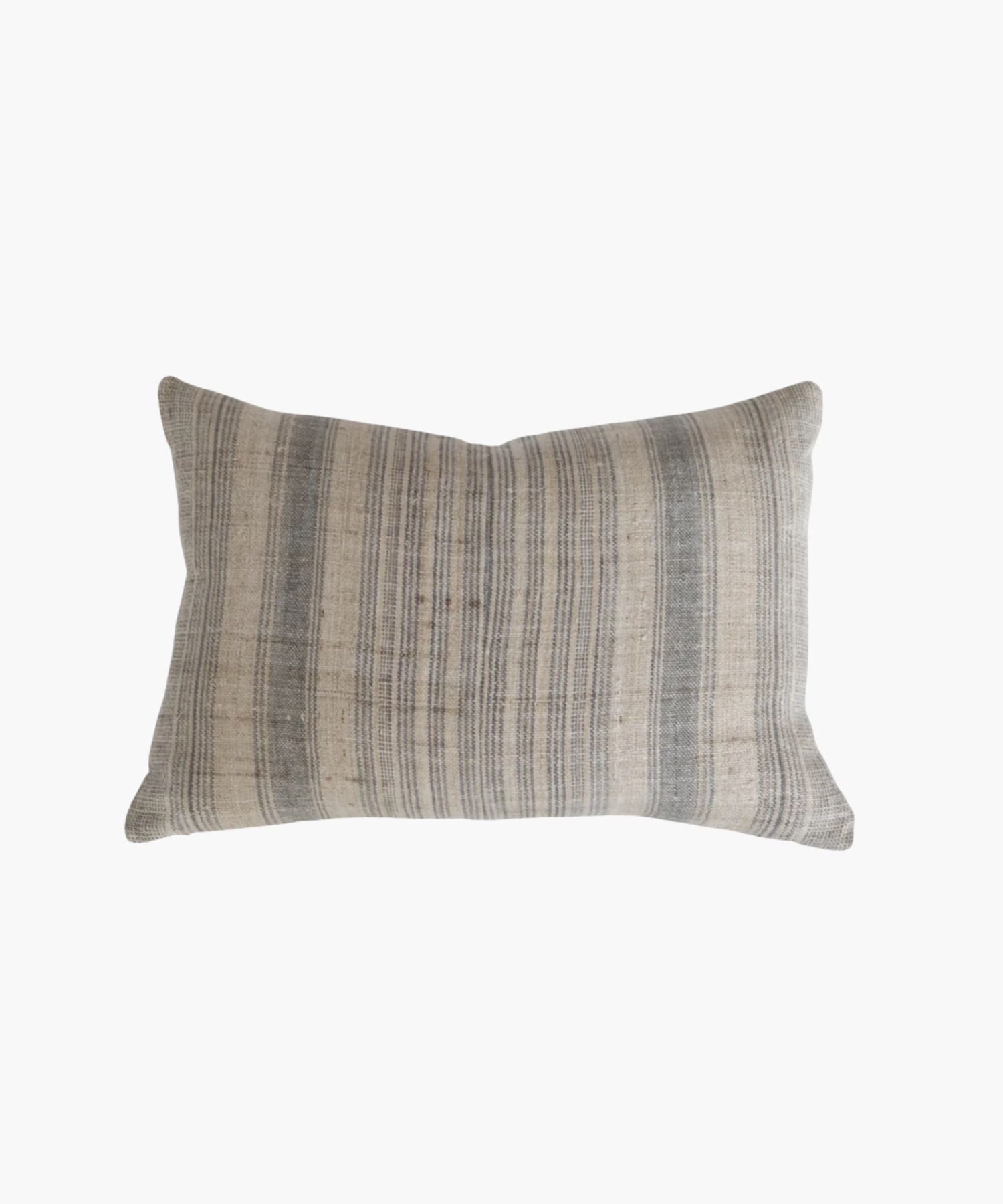 A rectangular or lumbar pillow cover with a neutral hemp background features vertical grey and blue stripes. The texture appears soft and slightly textured, conveying a cozy and rustic feel. | Wildwood Home Co.
