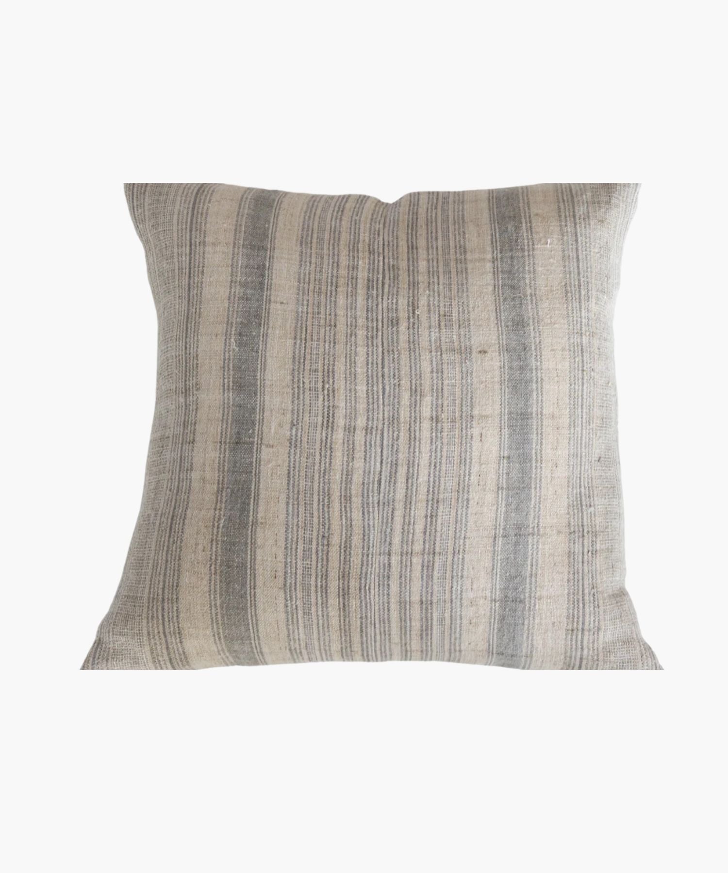 A square pillow cover with a neutral hemp background features vertical grey and blue stripes. The texture appears soft and slightly textured, conveying a cozy and rustic feel. | Wildwood Home Co.
