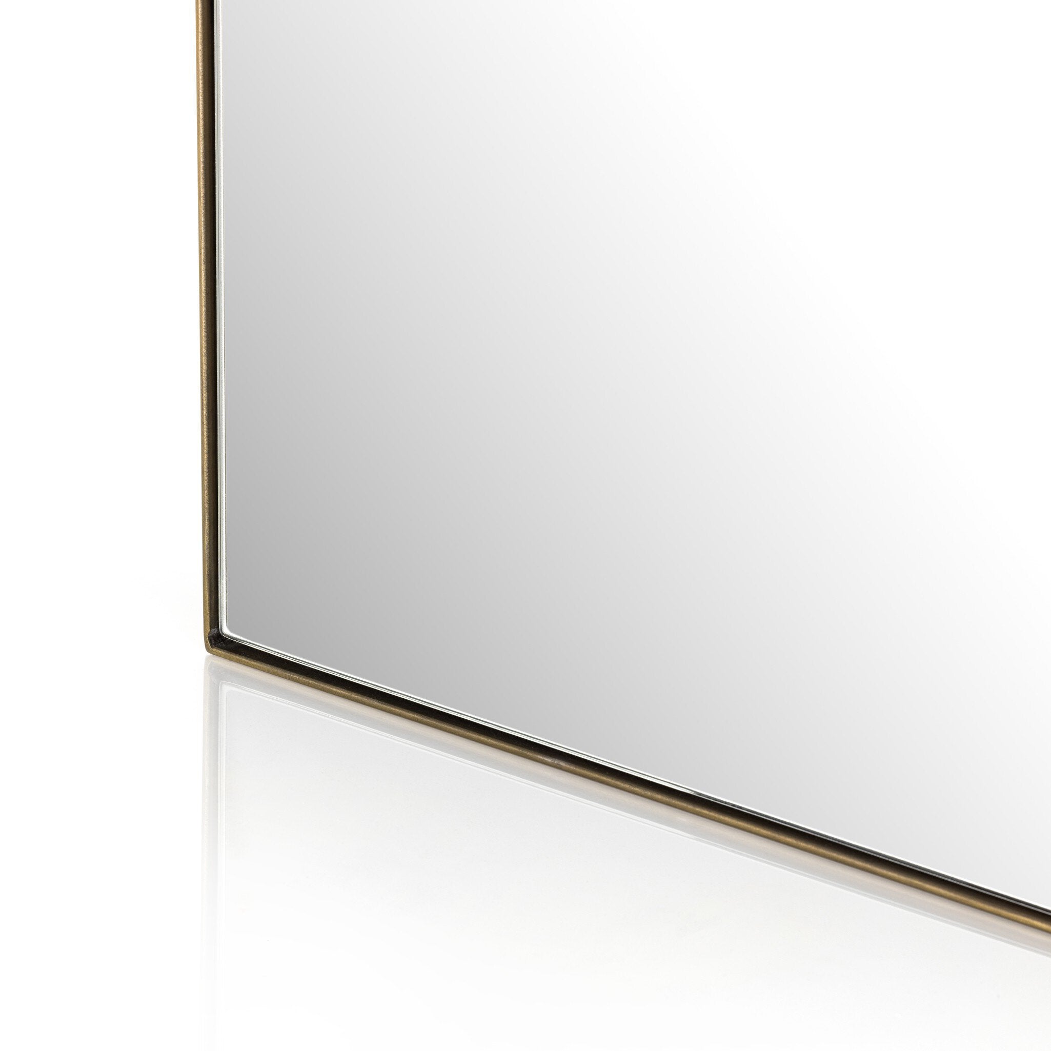 Rectangular floor length mirror with curved detail and a gold frame on a white background.