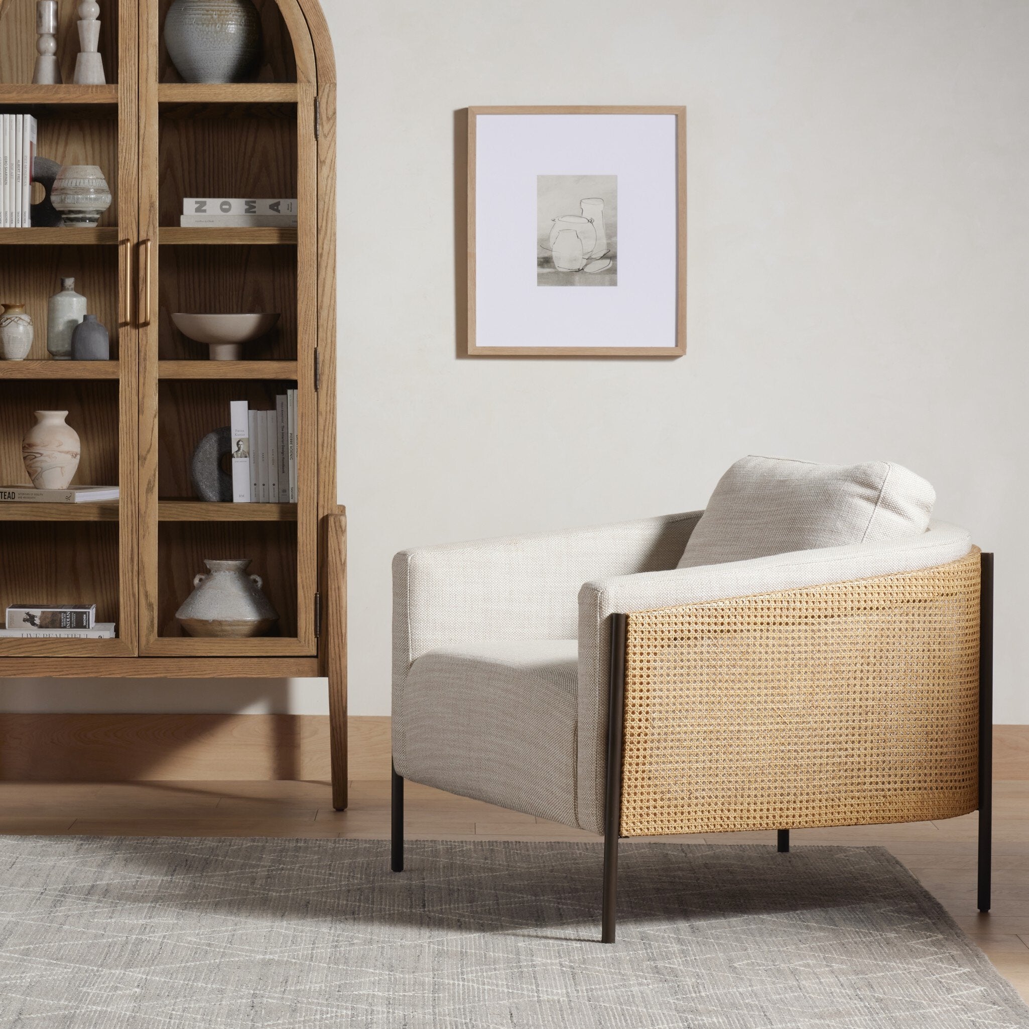 Modern armchair with wicker backrest in a living room setting. | Wildwood Home Co.