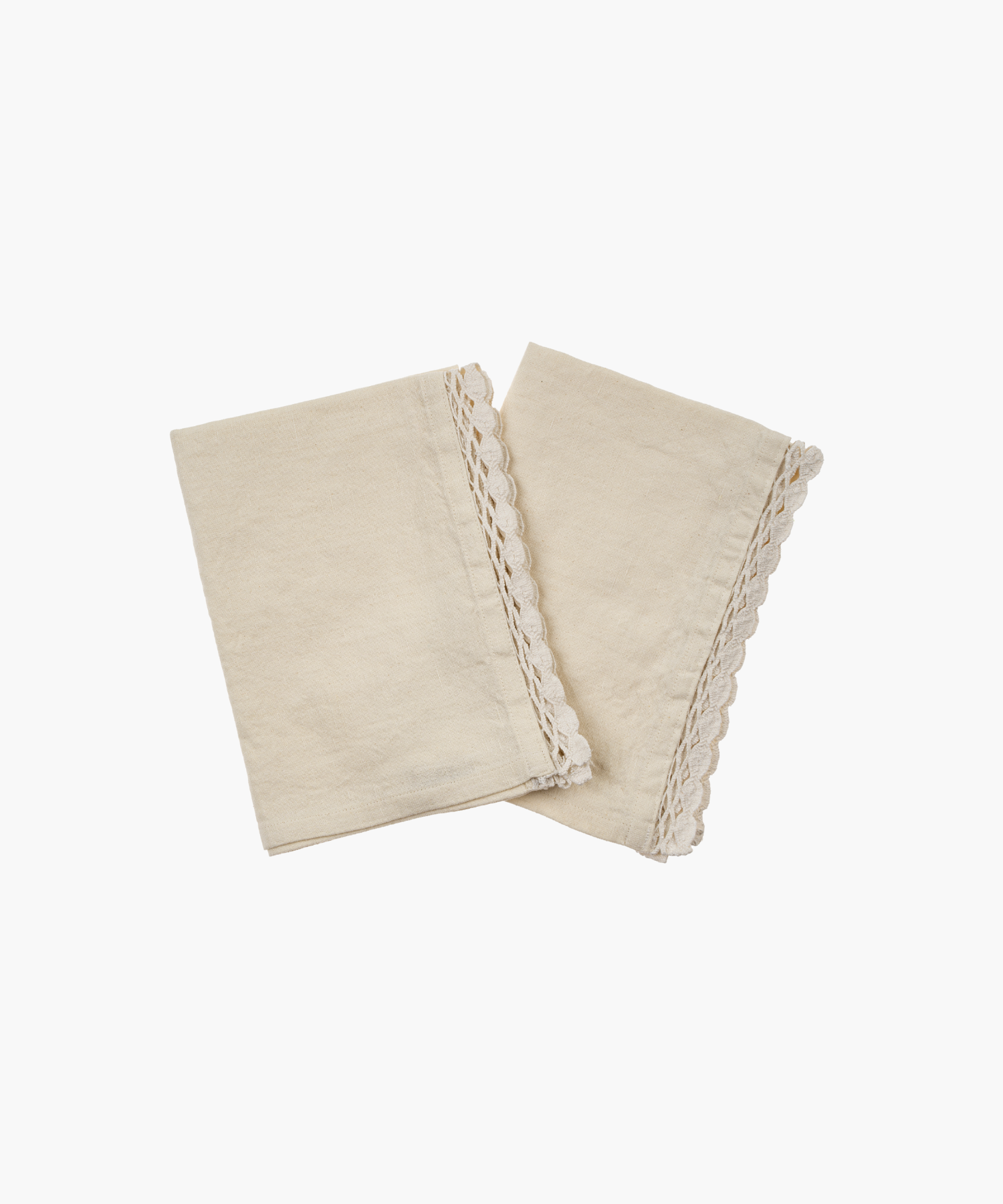 Two soft cotton linen napkins with scalloped lace edges, elegantly arranged and folded. They convey a rustic and cozy aesthetic. | Wildwood Home Co.