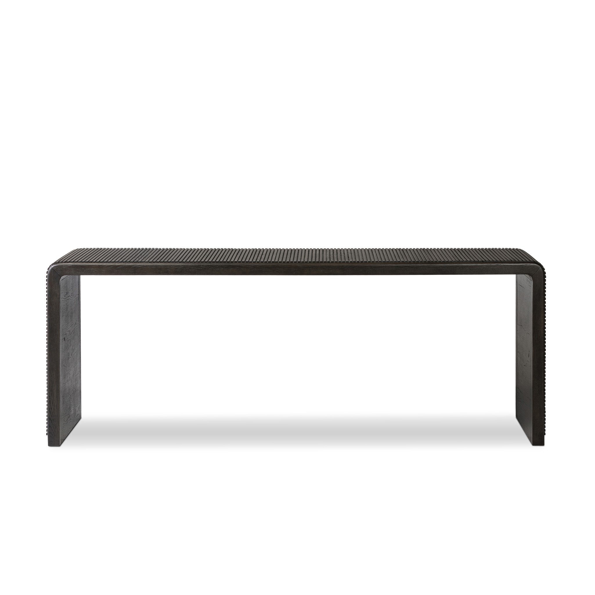 Smoked black oak console table with reeding and rounded edges on a white background. | Wildwood Home Co.