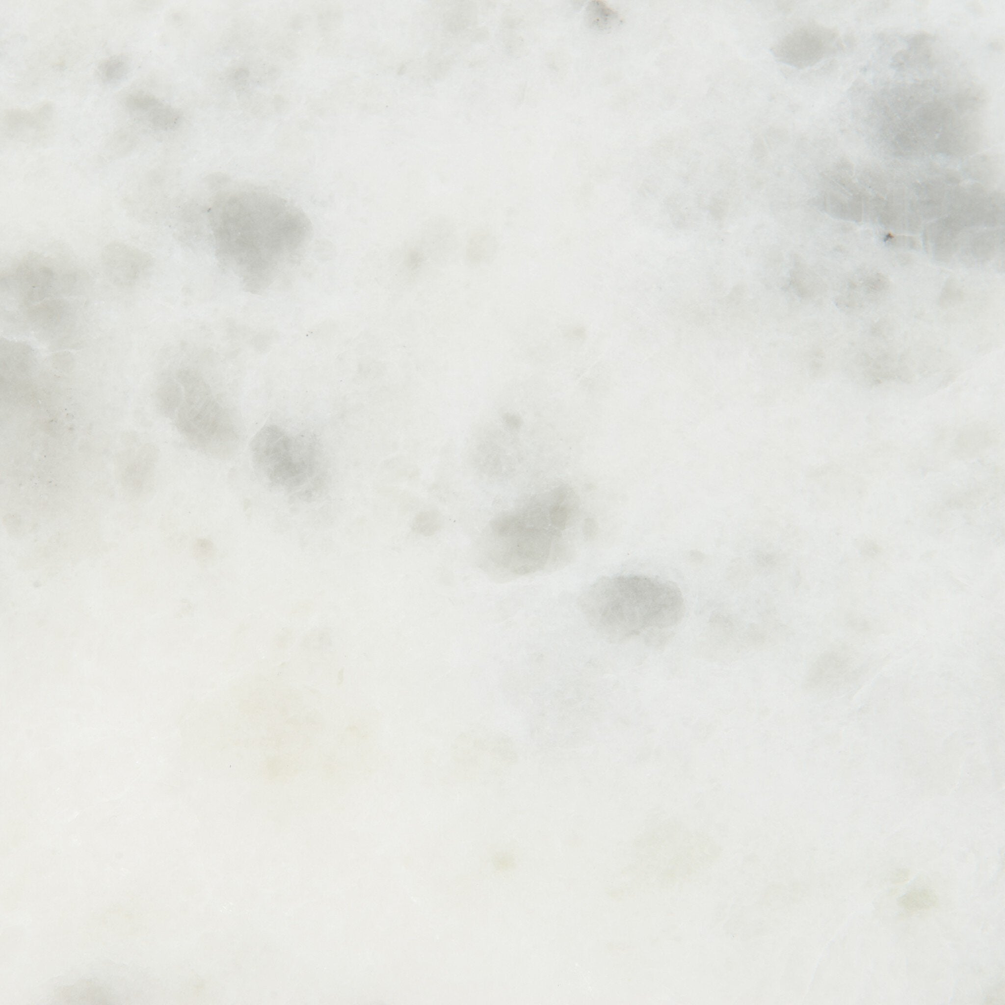 Close-up of a light gray marble table top showi the stones pattern and texture.